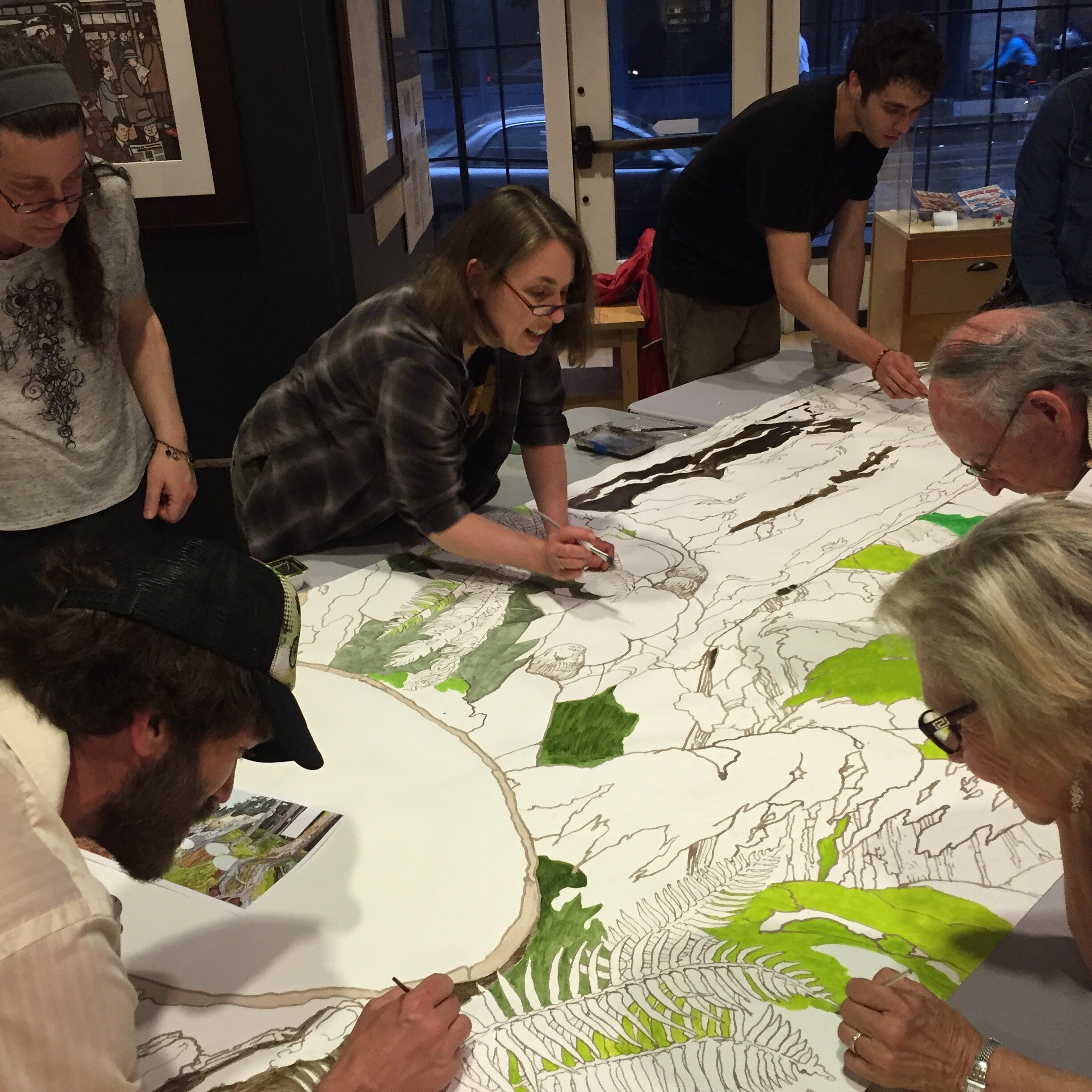 First Friday art-walkers came into Klondike to help make a mural of a restored forest ecosystem.