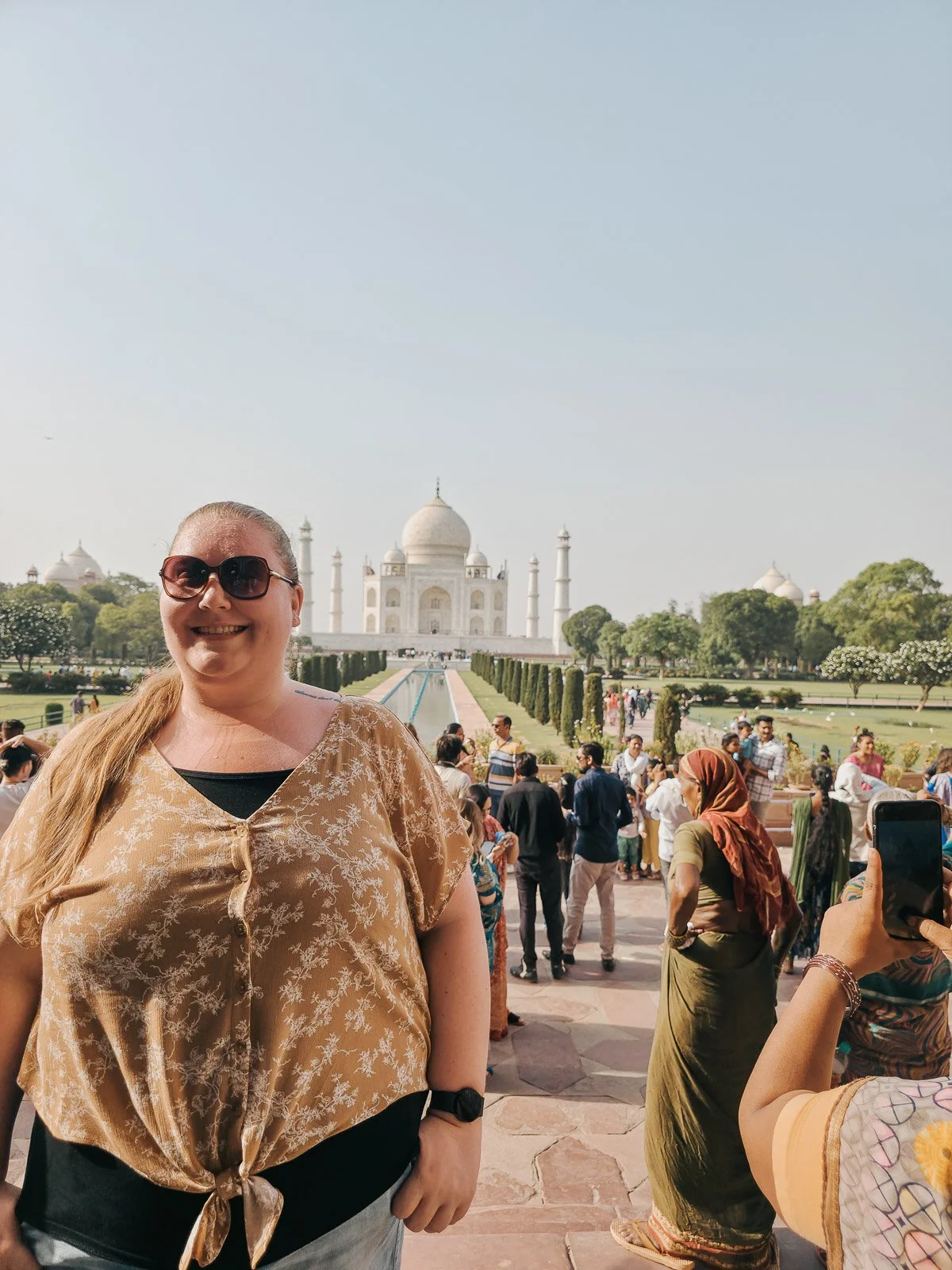Traveler standing with the Taj Mahal in the background in Agra, India
