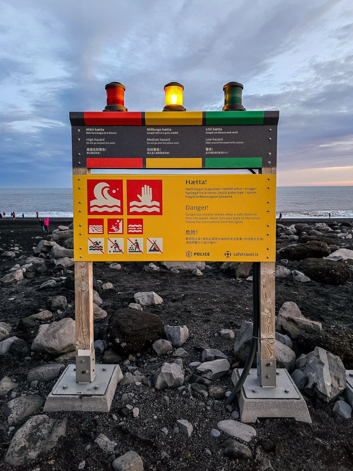 Red, yellow and green sneaker wave warning lights at Reynisfjara Black Sand Beach