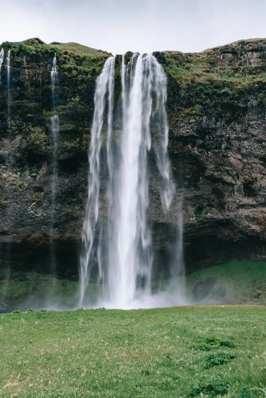 Seljalandsfoss waterfall dropping over a green cliff on Iceland's South Coast