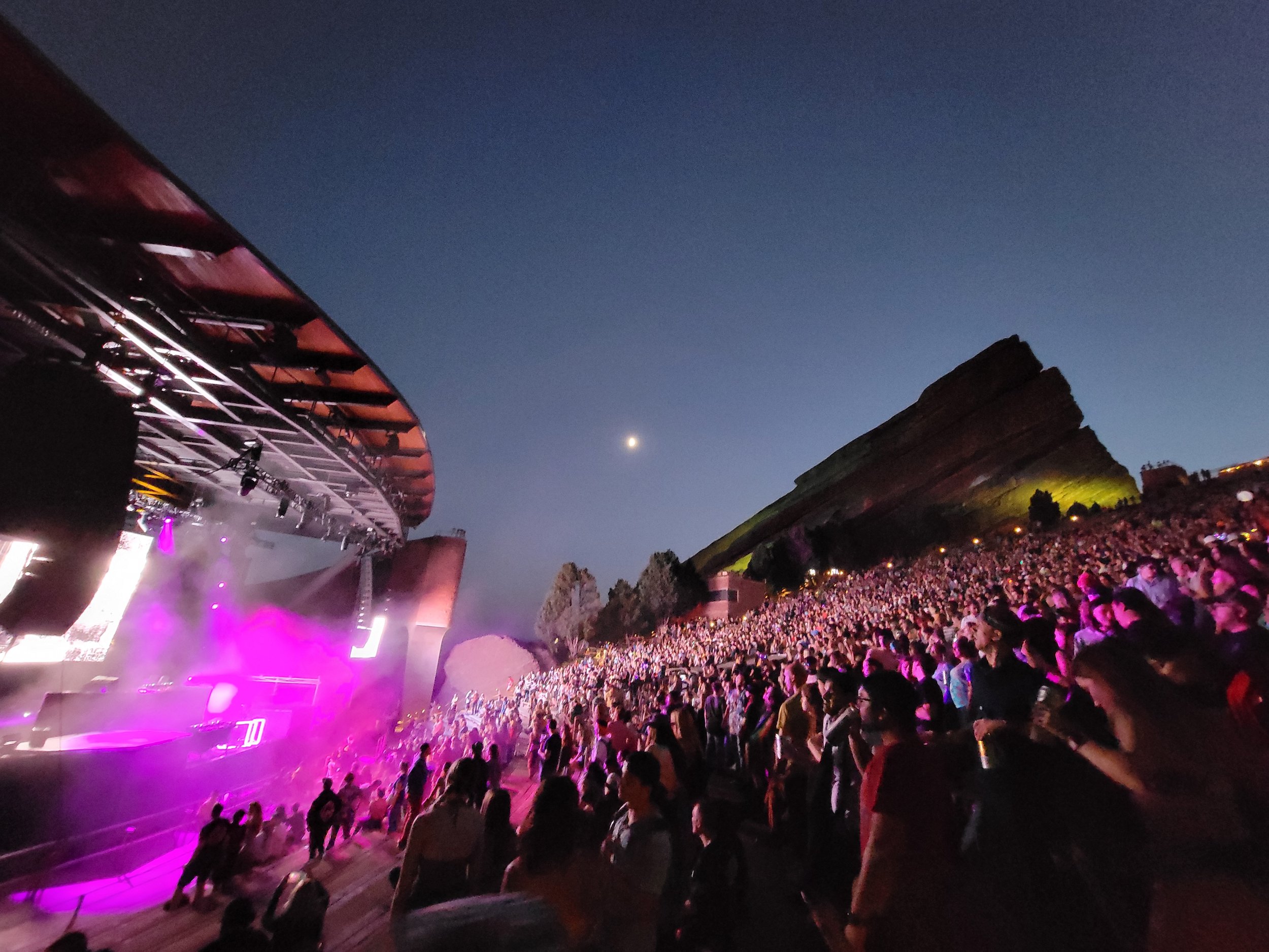 view of red rocks amphitheater at night with a concert performing and purple lights