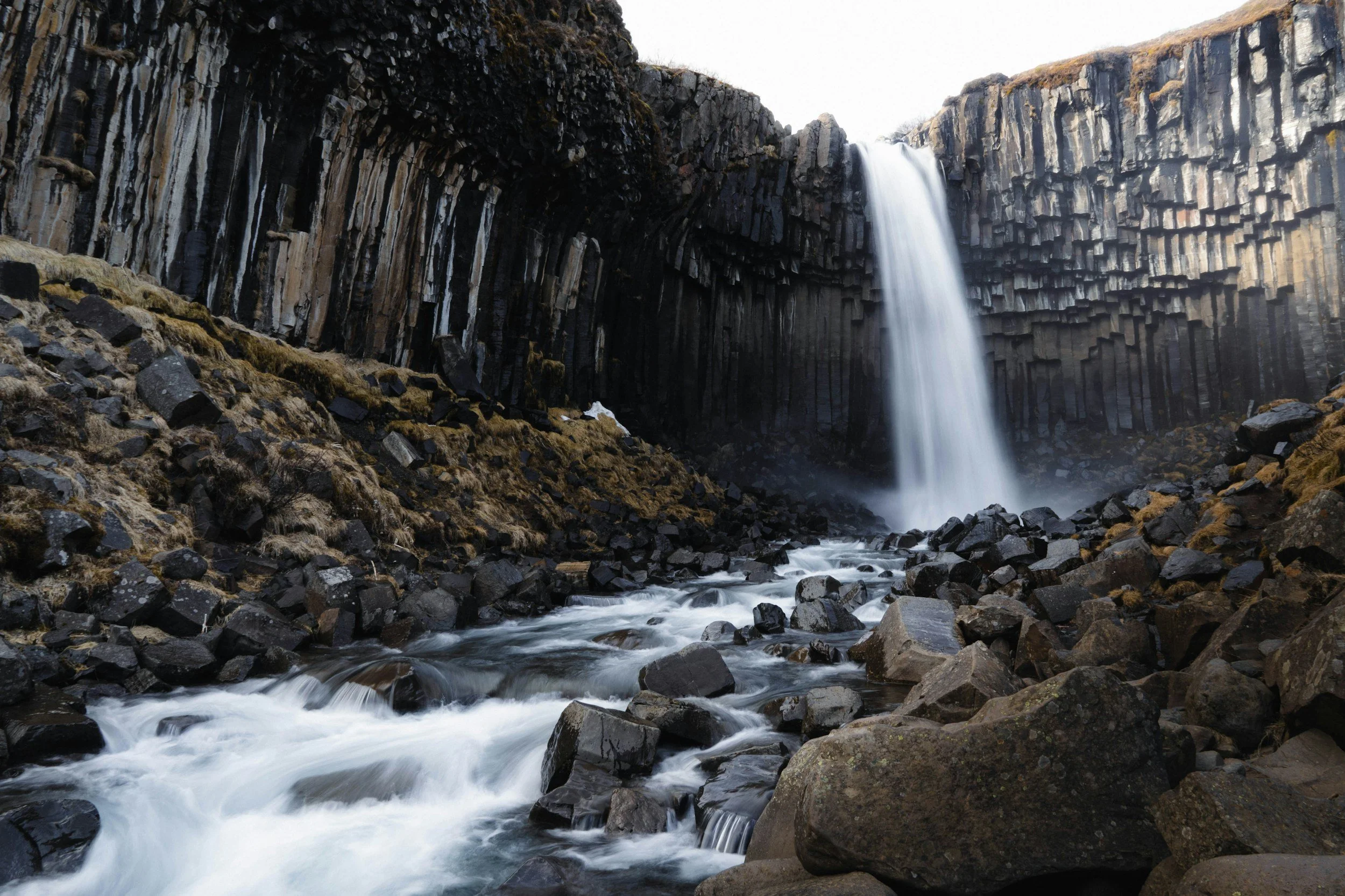 Svartifoss waterfall flowing over a wall of dark basalt columns in Skaftafell, Iceland