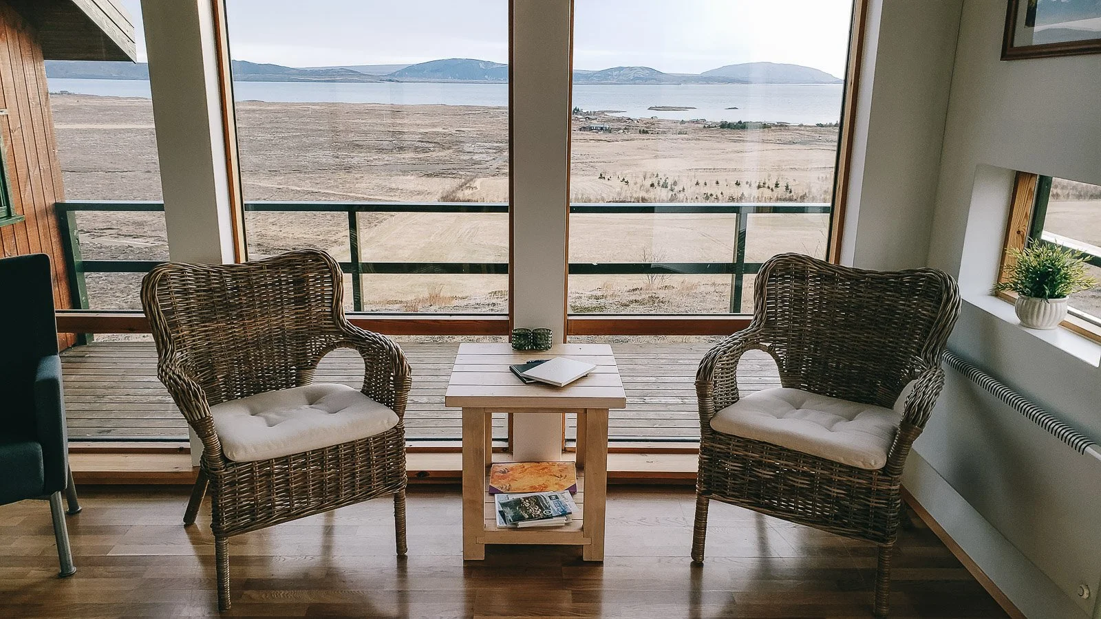 Hotel room in Iceland with chairs facing large windows overlooking the landscape