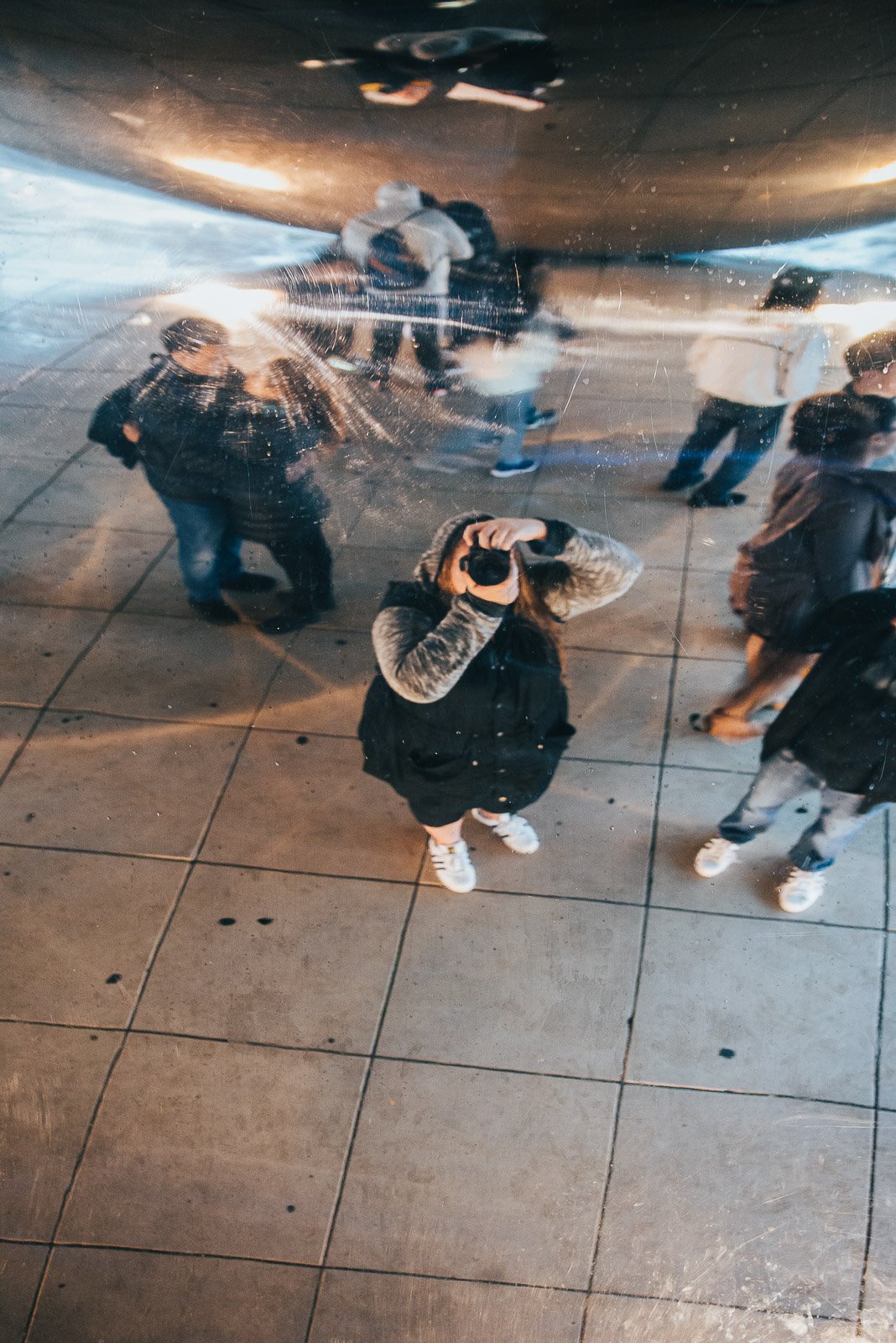 Photographer taking a photo reflected in a mirrored surface
