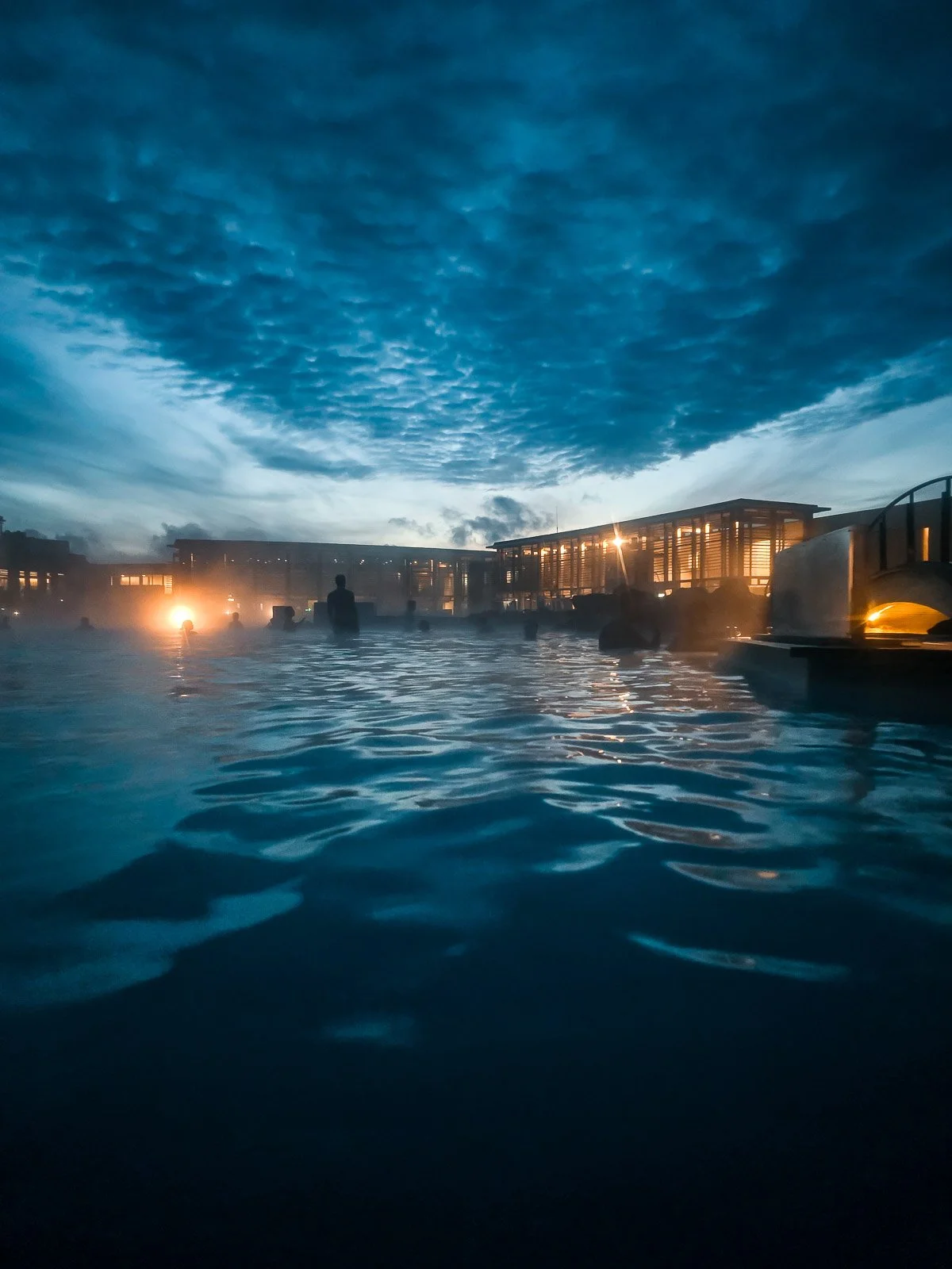 Blue Lagoon geothermal spa in Iceland at dusk with steam rising from the water