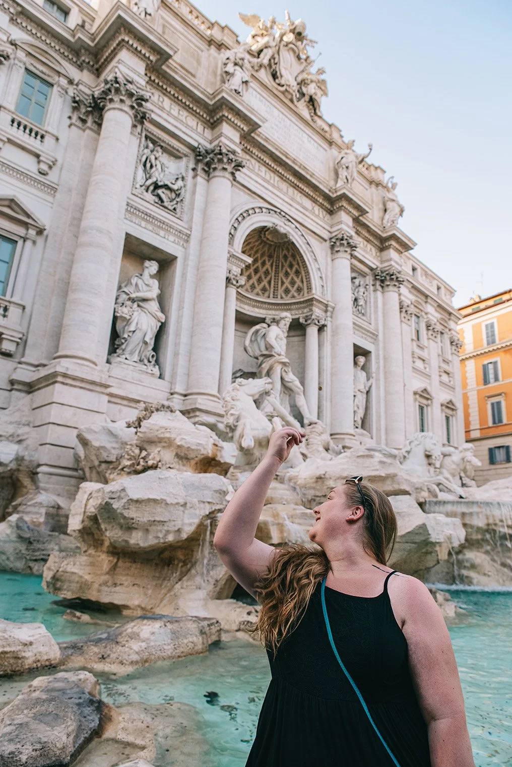 karen throwing coin in trevi fountain in rome italy