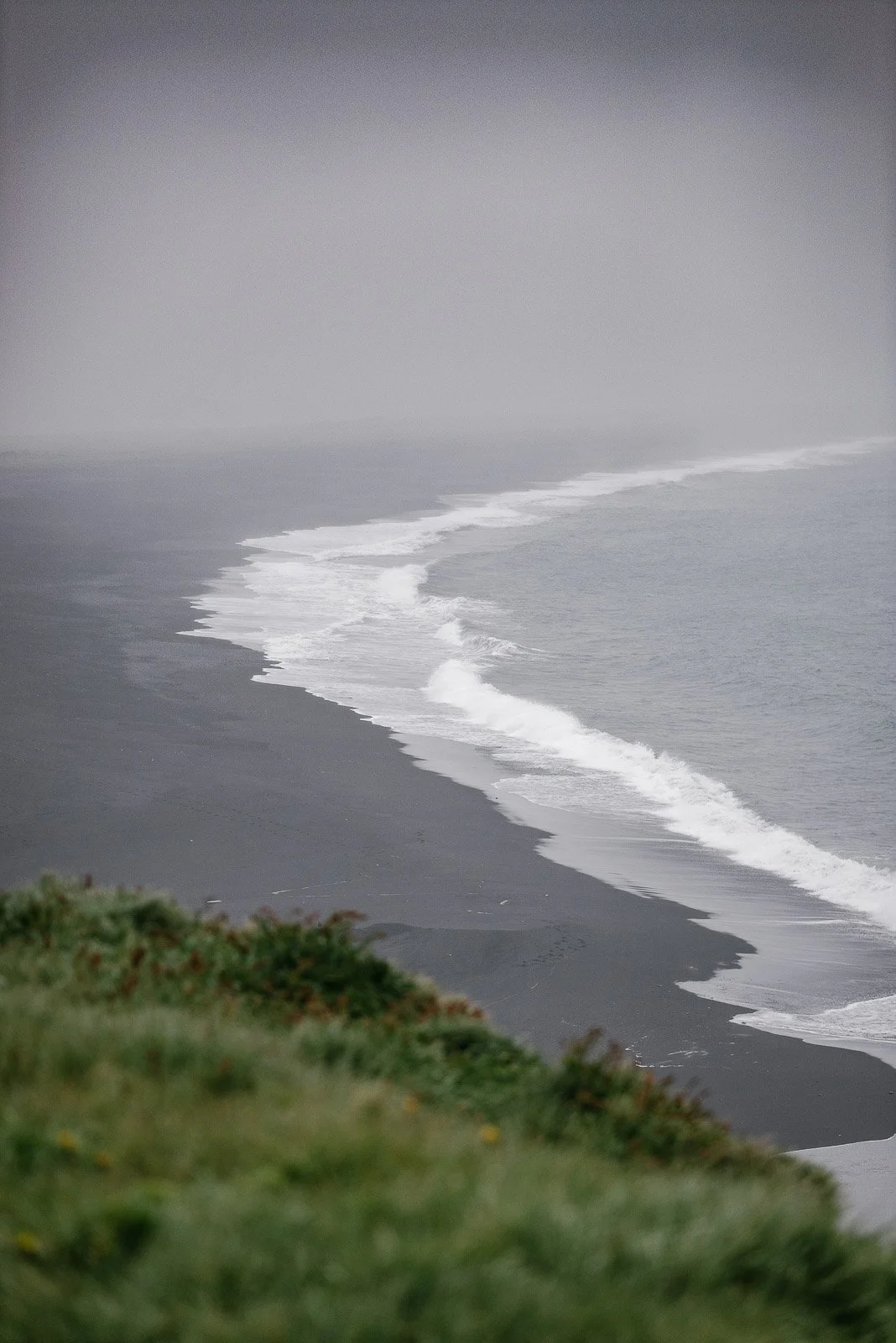 Black sand coastline and ocean waves viewed from Dyrhólaey in Iceland