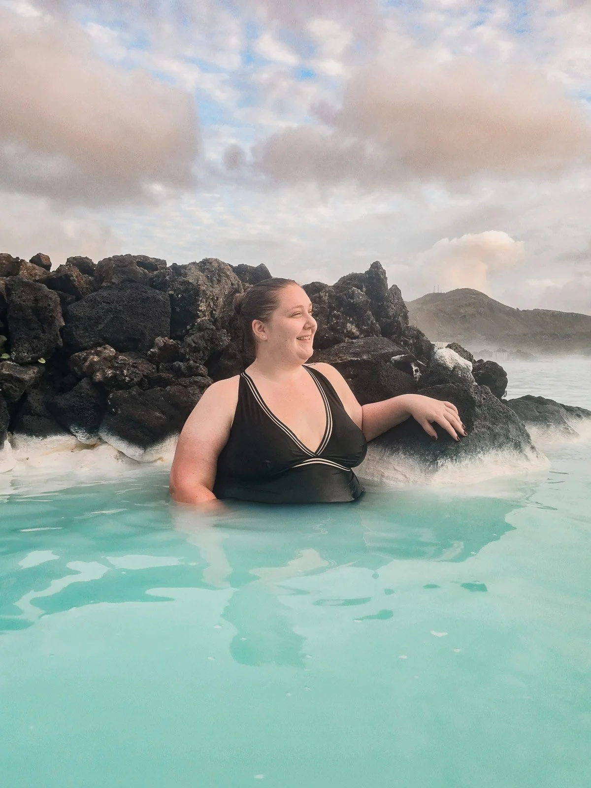 Traveler relaxing in the turquoise geothermal water of the Blue Lagoon in Iceland