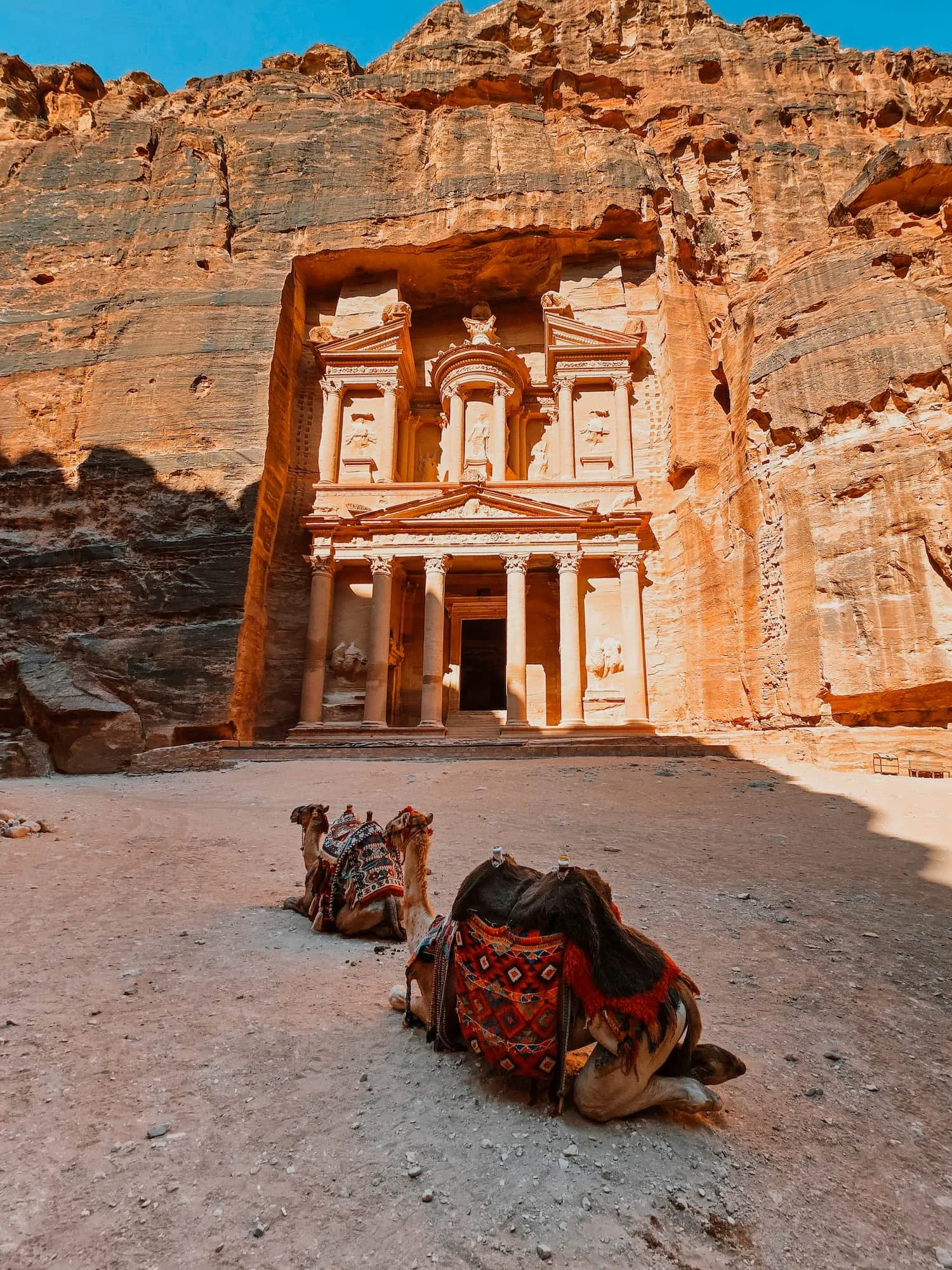 The Treasury at Petra in Jordan with two camels resting in the foreground