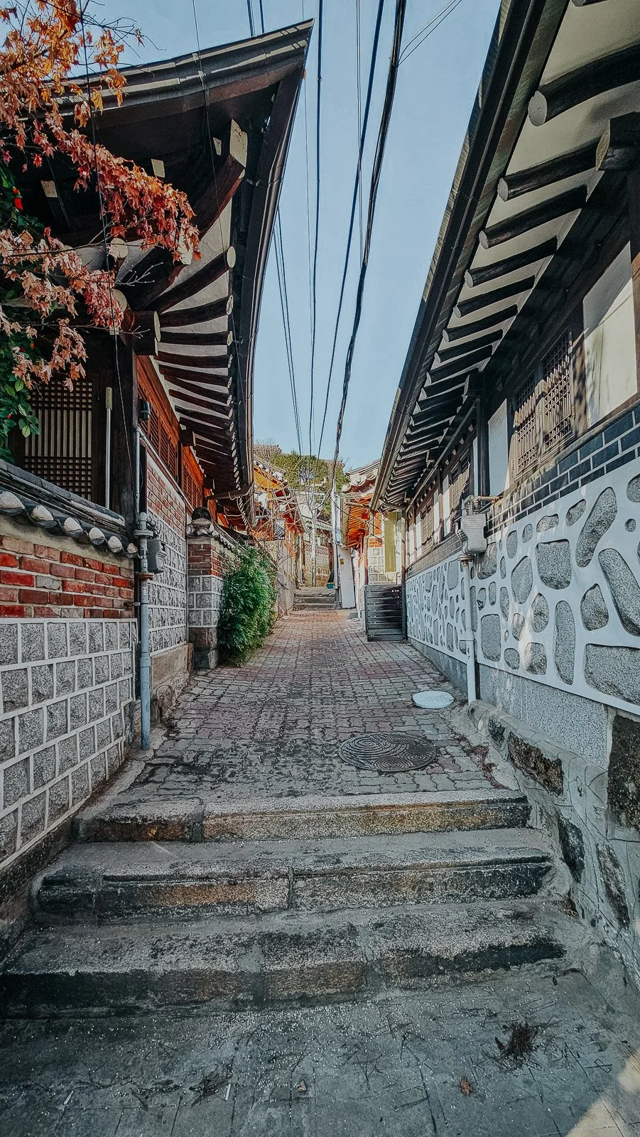 Narrow alley lined with traditional hanok homes in Seoul, South Korea.