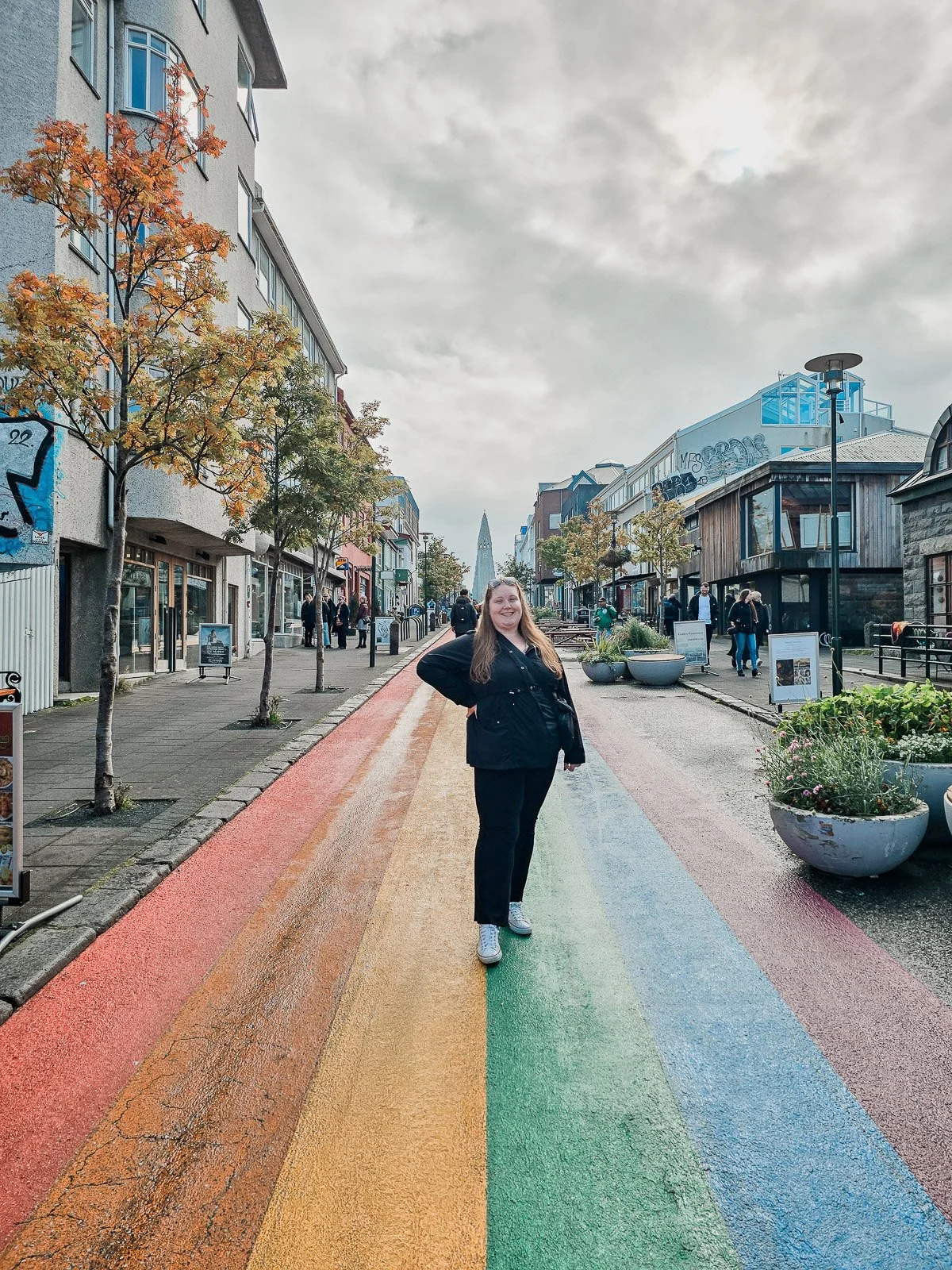 Traveler standing on Rainbow Street in downtown Reykjavík, Iceland