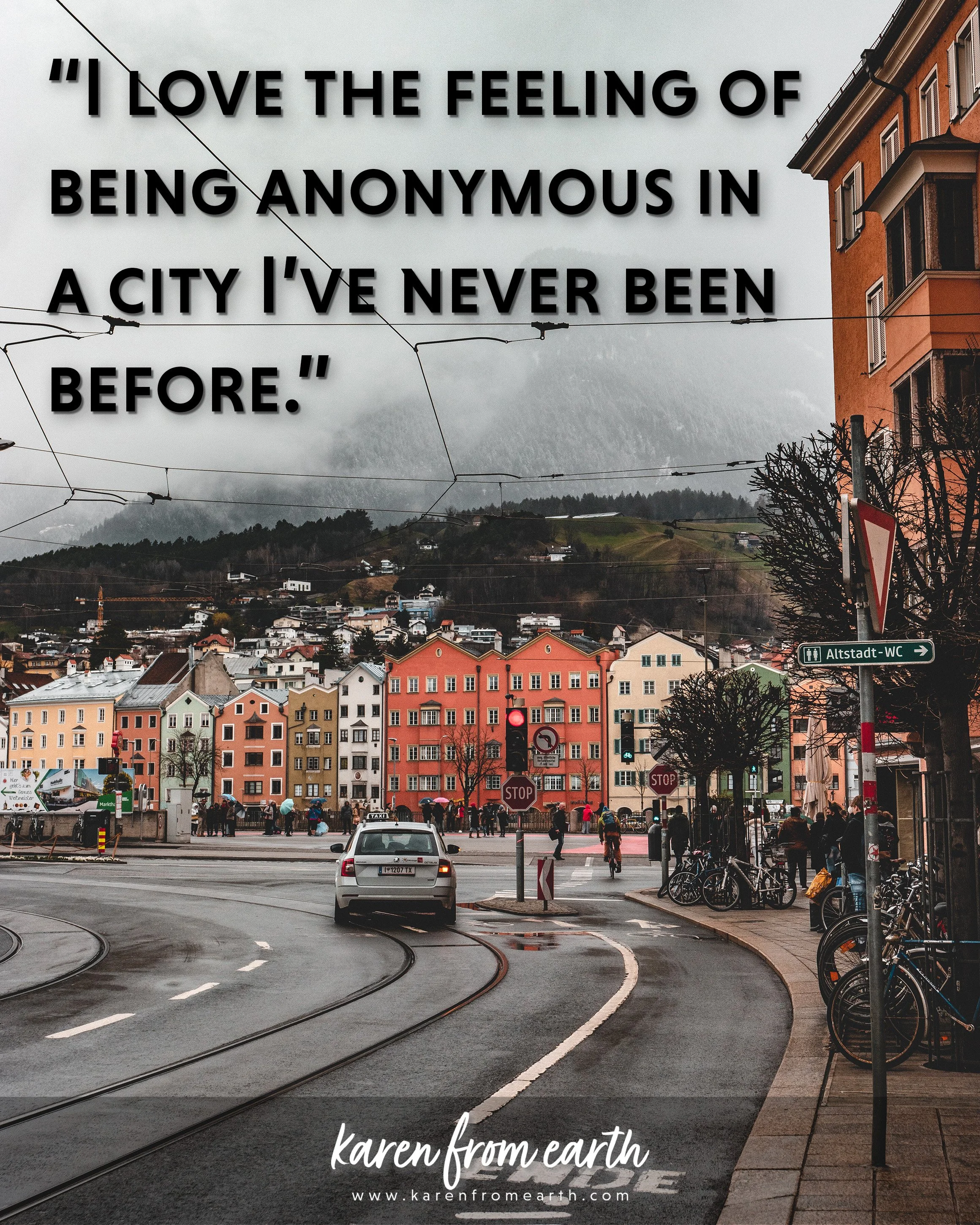 Travel quote about exploring unfamiliar cities over a photograph of colorful buildings, tram tracks and surrounding mountains in Innsbruck, Austria.