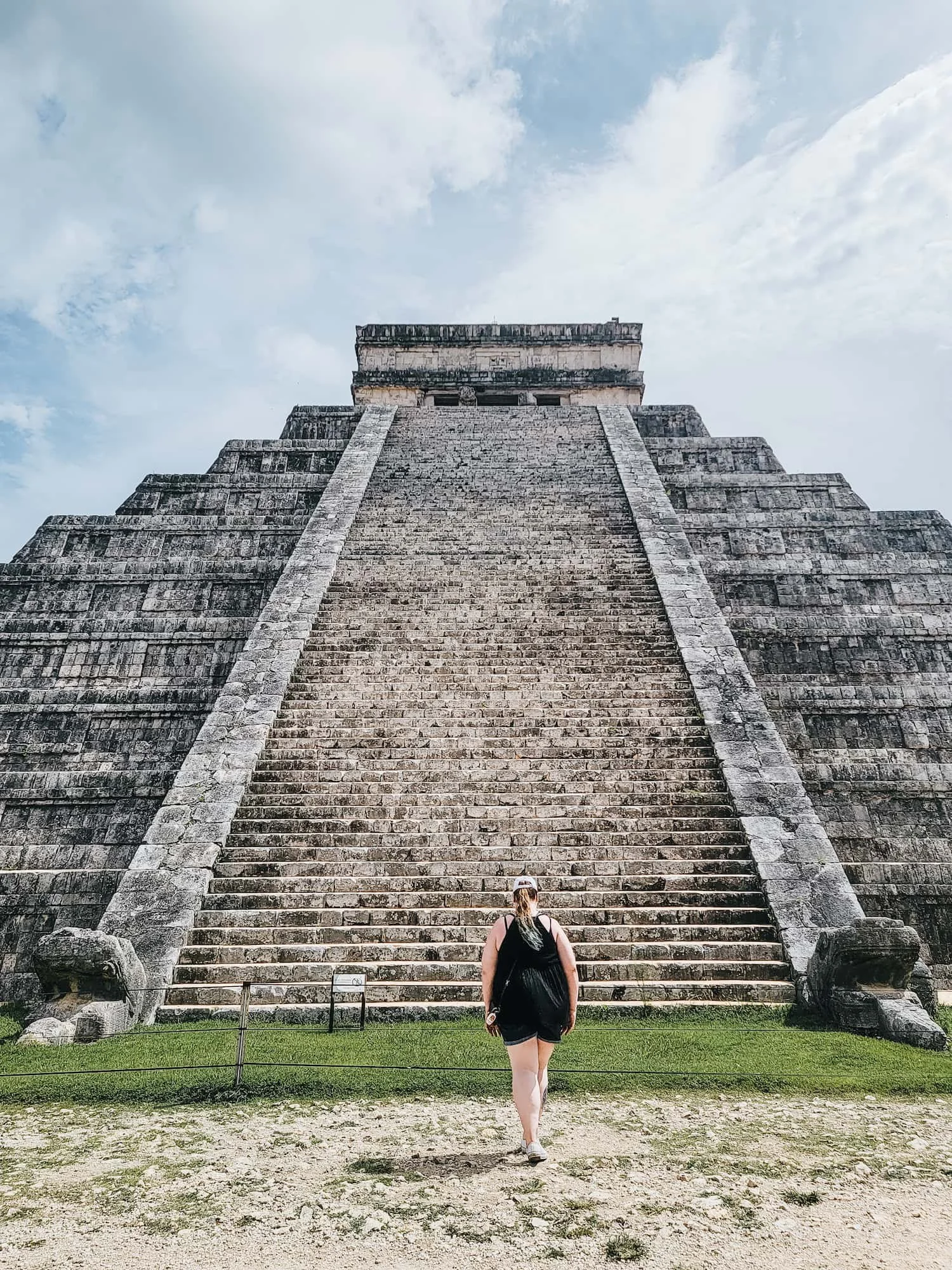 Traveler walking toward El Castillo pyramid at Chichén Itzá in Mexico