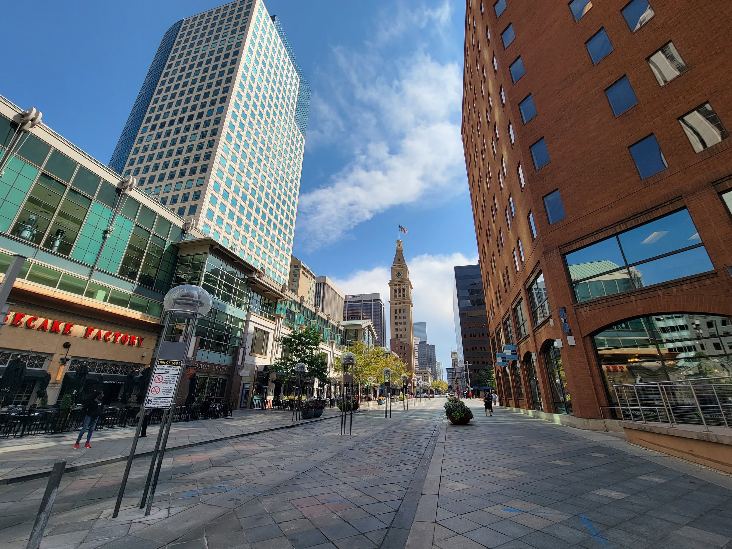 16th Street in downtown Denver with buildings and the Daniels and Fisher Tower in the distance