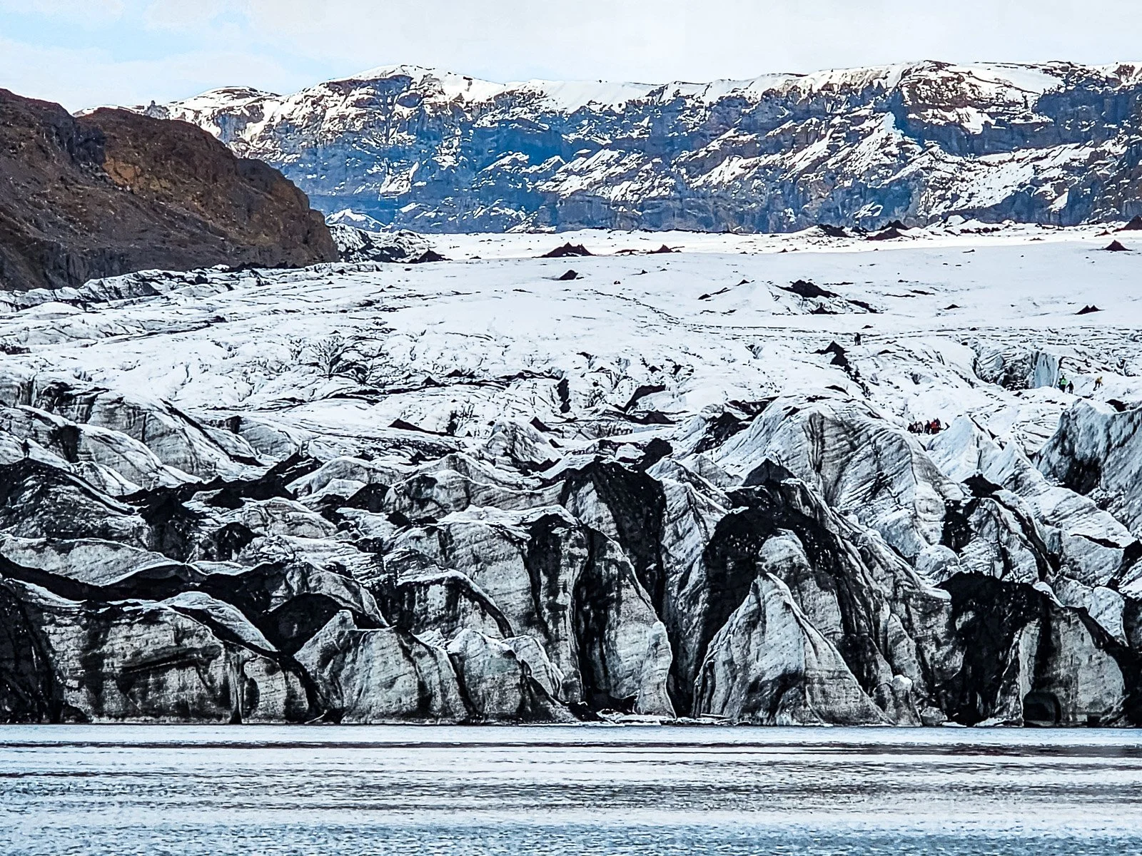 Sólheimajökull glacier covered in dark volcanic sediment on Iceland's South Coast