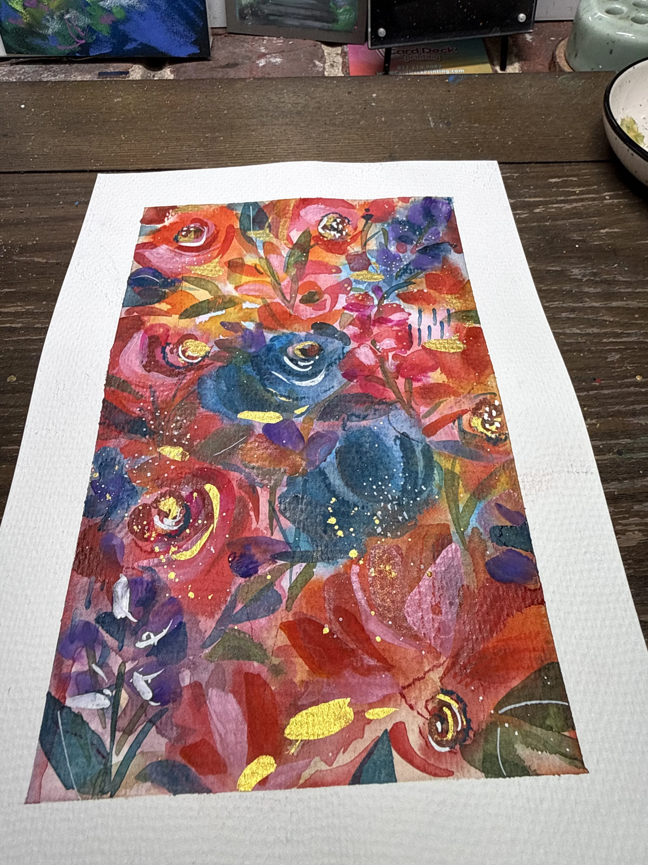 A colorful watercolor painting of a floral arrangement on white textured paper.