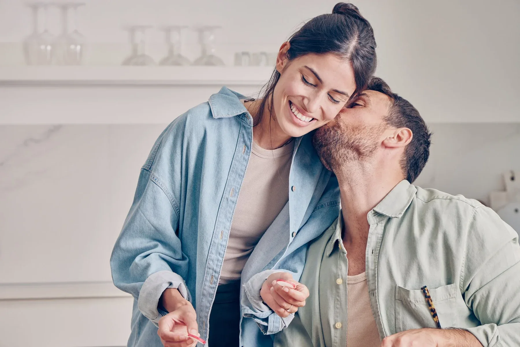 A happy couple laughing at home — relationship therapy with Sarah Borrell