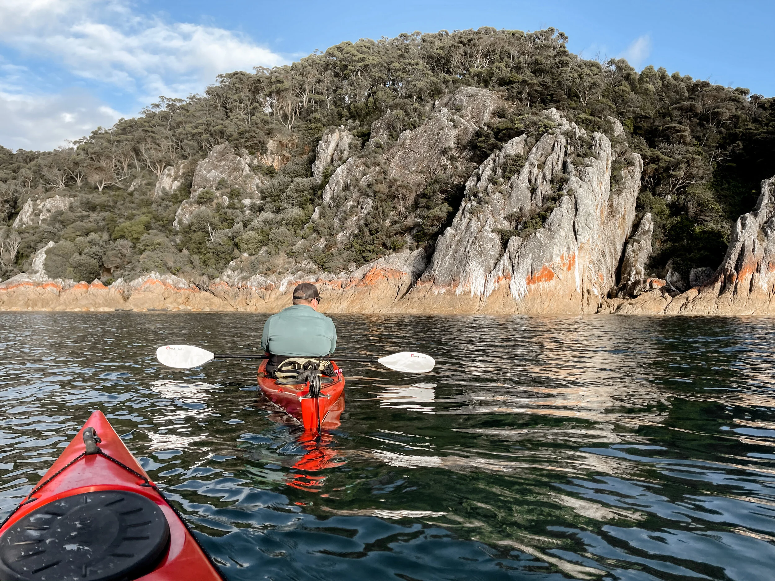 Richard kayaking on calm waters around Rocky Cape - Melissa Duniam