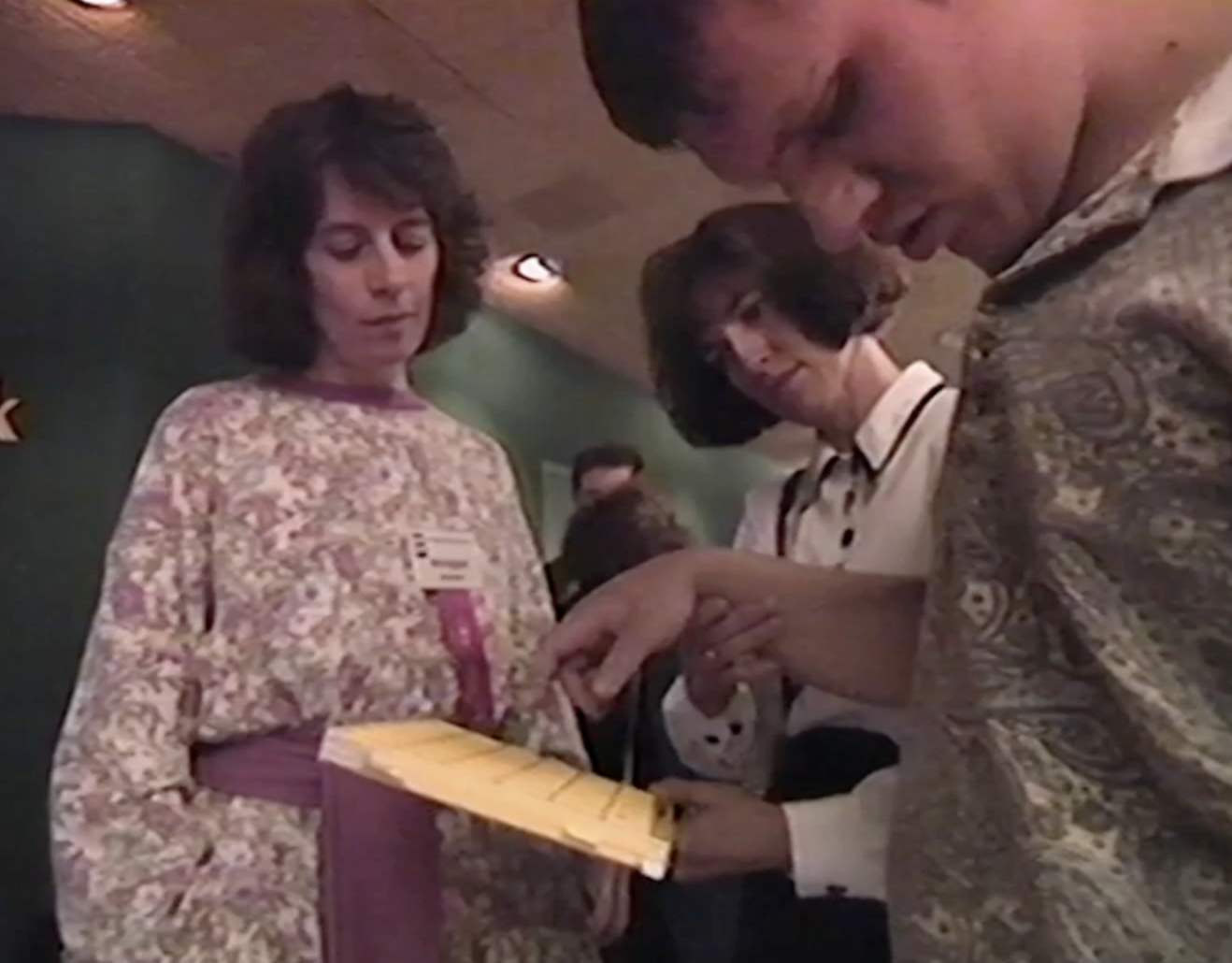Annegret Schubert talks with an FCed invidual who has his eye closed Prisoners of Silence.png