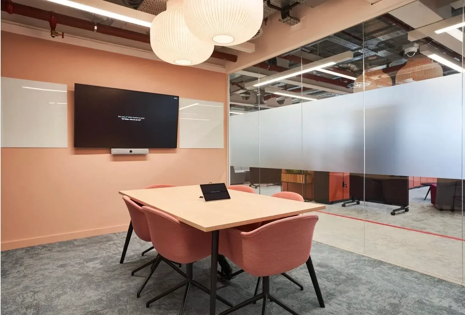 Meeting room with two glass whiteboards.webp