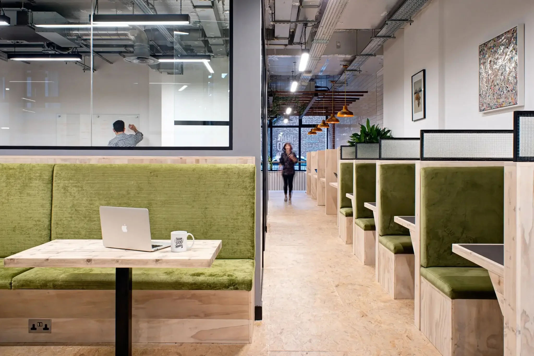 Office space with sofa booths in green.webp