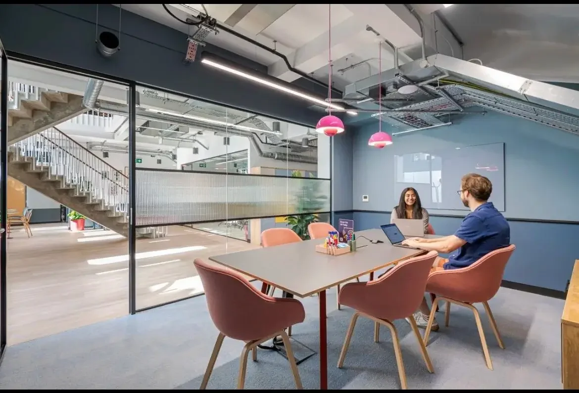 Two colleagues working in meeting room.webp