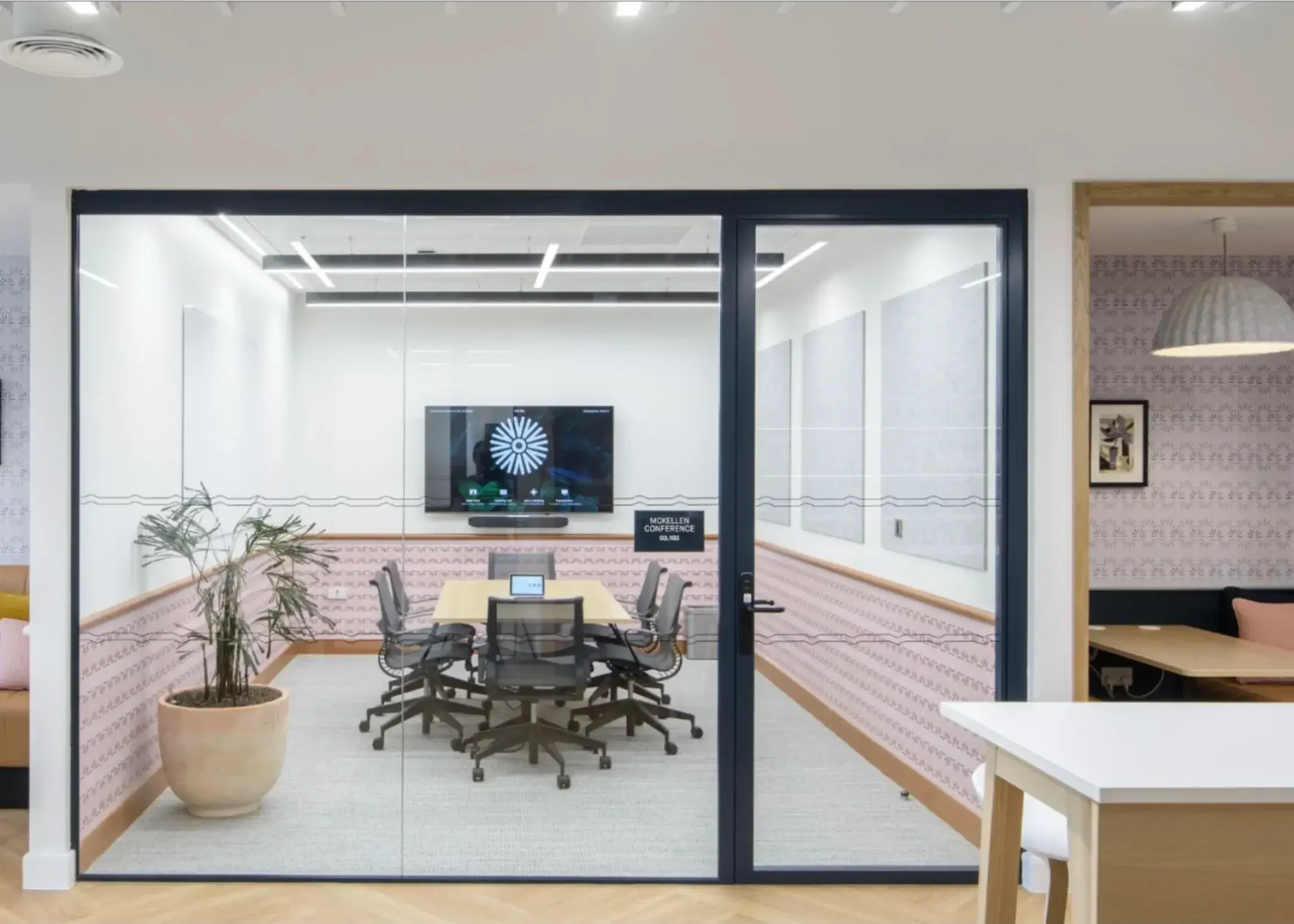 Outside of office space with a number of glass whiteboards.webp