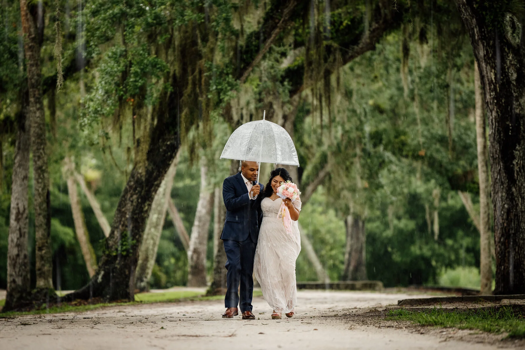wedding portraits under umbrella in the rain
