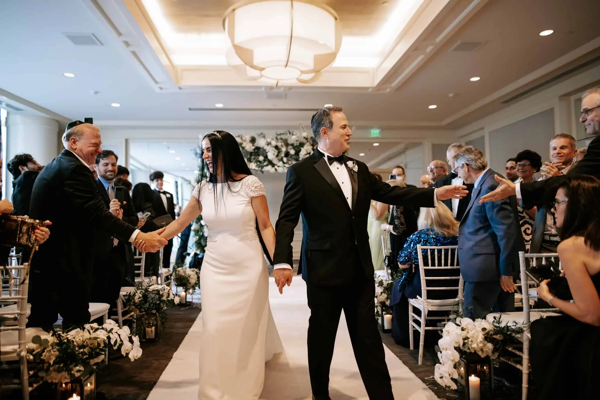 bride and groom on the aisle at the four seasons miami captured by miami wedding photographers