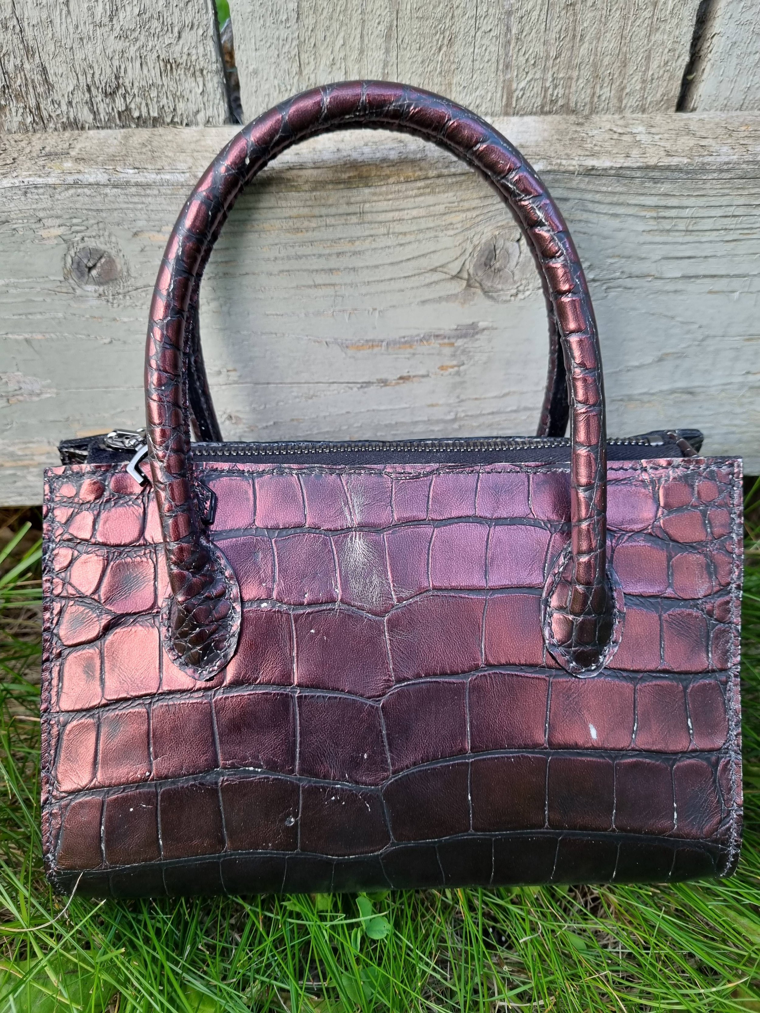Rear view of a luxury dark cherry alligator leather leather handbag, made by Pila Luxuria in Canada.