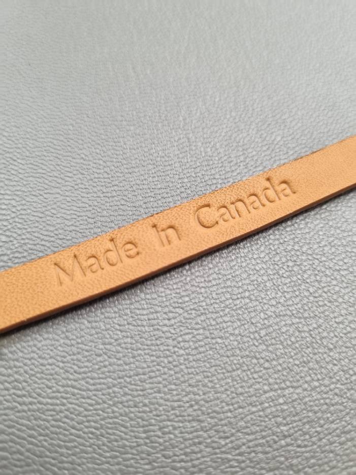 Made In Canada embossed on a luxury cognac crocodile bracelet with a magnetic clasp, made by Pila Luxuria in Canada.