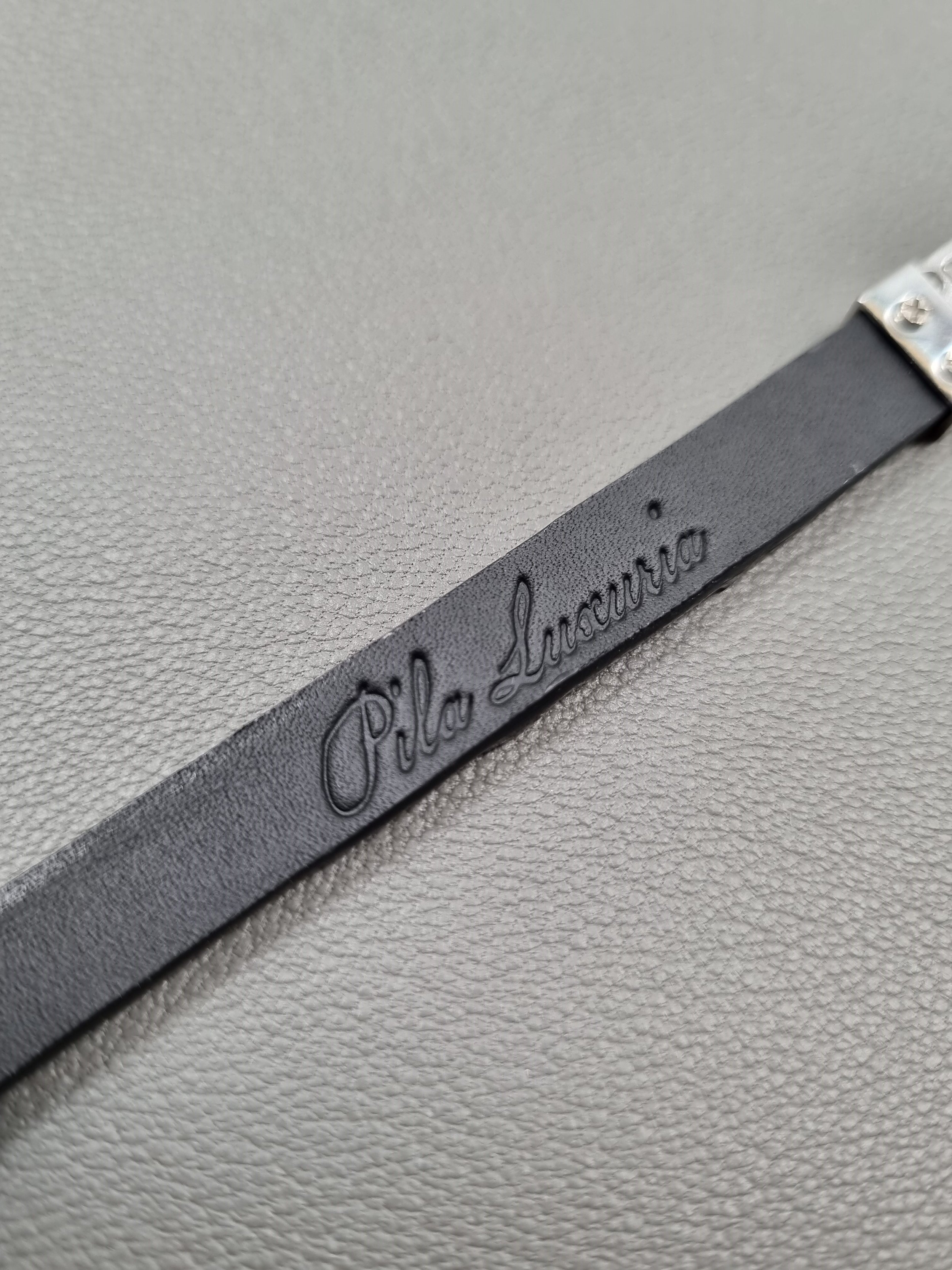 Black crocodile leather bracelet with Pila Luxuria embossing.