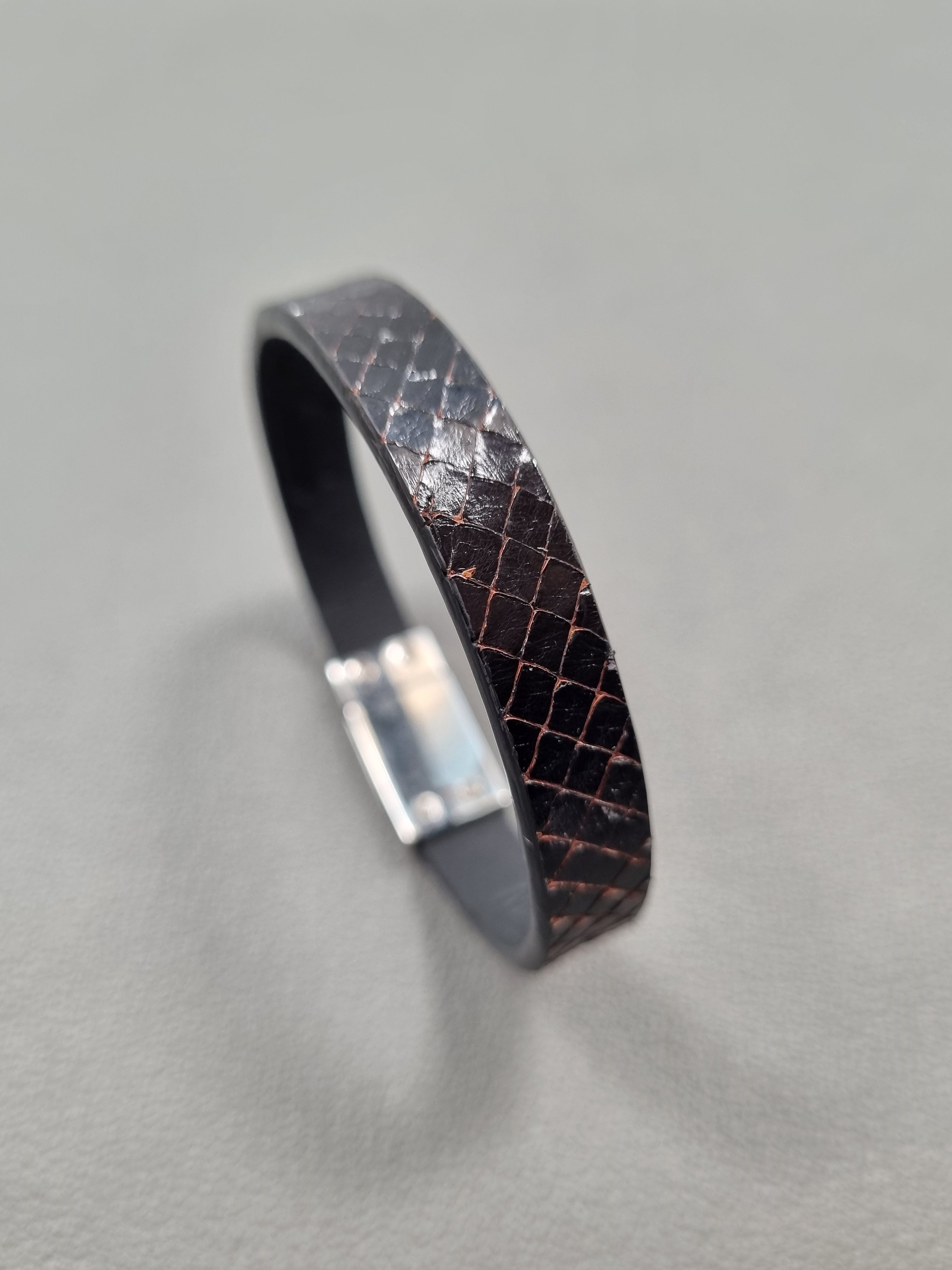 Black python leather bracelet with black calfskin lining.
