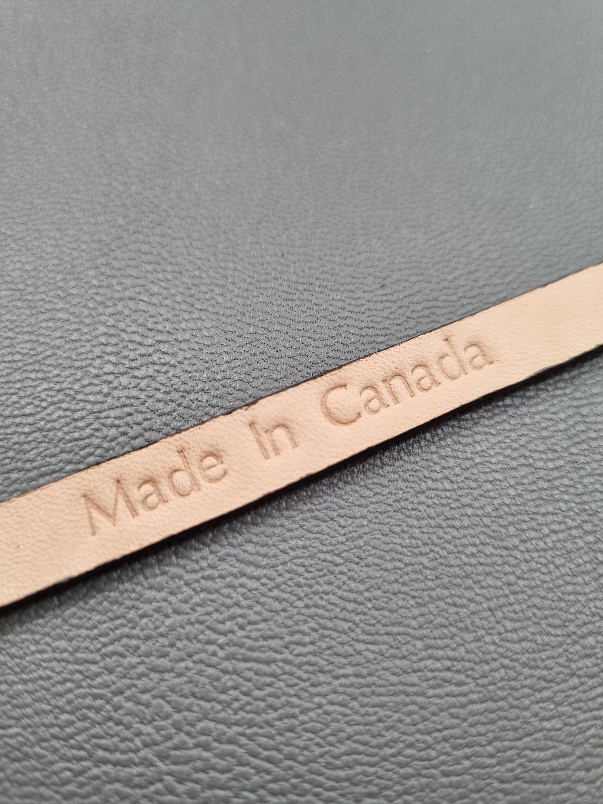 Embossed Made in Canada emblem of a luxury brown calfskin leather bracelet with a magnetic clasp, made by Pila Luxuria in Canada.