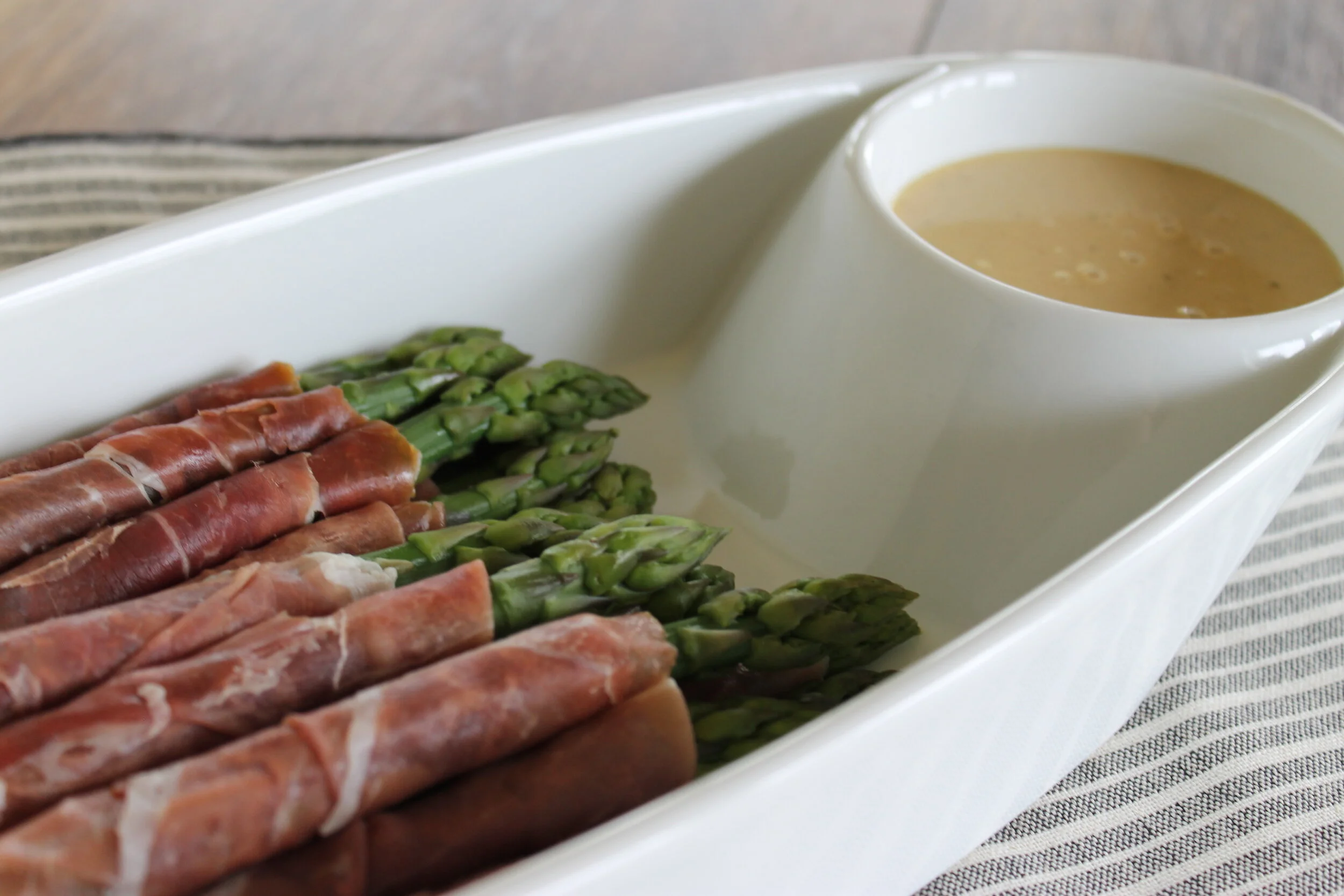 ASPARAGUS WRAPPED in PROSCUITTO with a savory dipping sauce