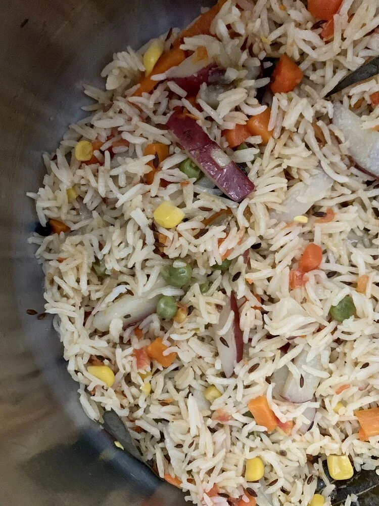 Happy smiling woman with curly hair lounging on couch.