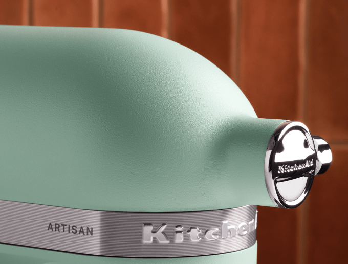 Roll Cut Studios campaign for KitchenAid Appliances Color of the Year. Photograph by Huge Galdones of spearmint green KitchenAid artisan stand mixer with metallic band and chrome attachment knob.