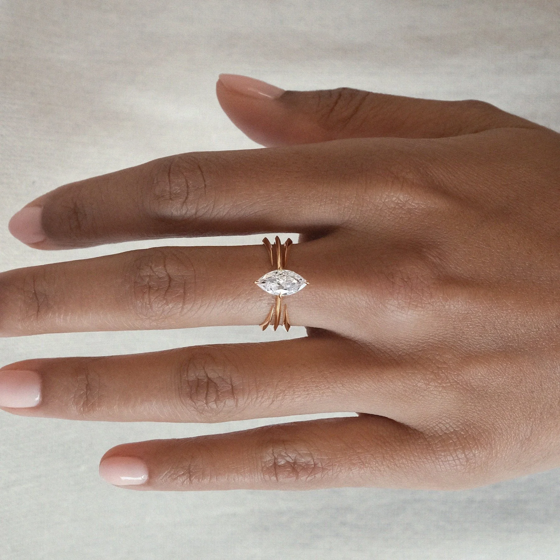 Defined by its sharp, geometric centre and dual cradle rings, the Apox Ring evokes a sense of structured power and timeless ritual. At its heart sits a brilliant diamond in a fierce tiger claw cross setting &mdash; a symbol of both protection and com