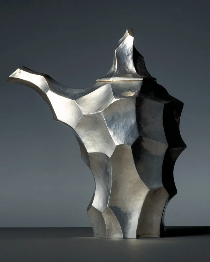 Abstract silver teapot by Danish goldsmith, Arje Griegst. Inspired by the Baroque and the Orient, Griegst&rsquo;s free sculptural forms stand in striking contrast to rigid modernism. In his hands, solid materials seemed to dissolve into a liquid stat