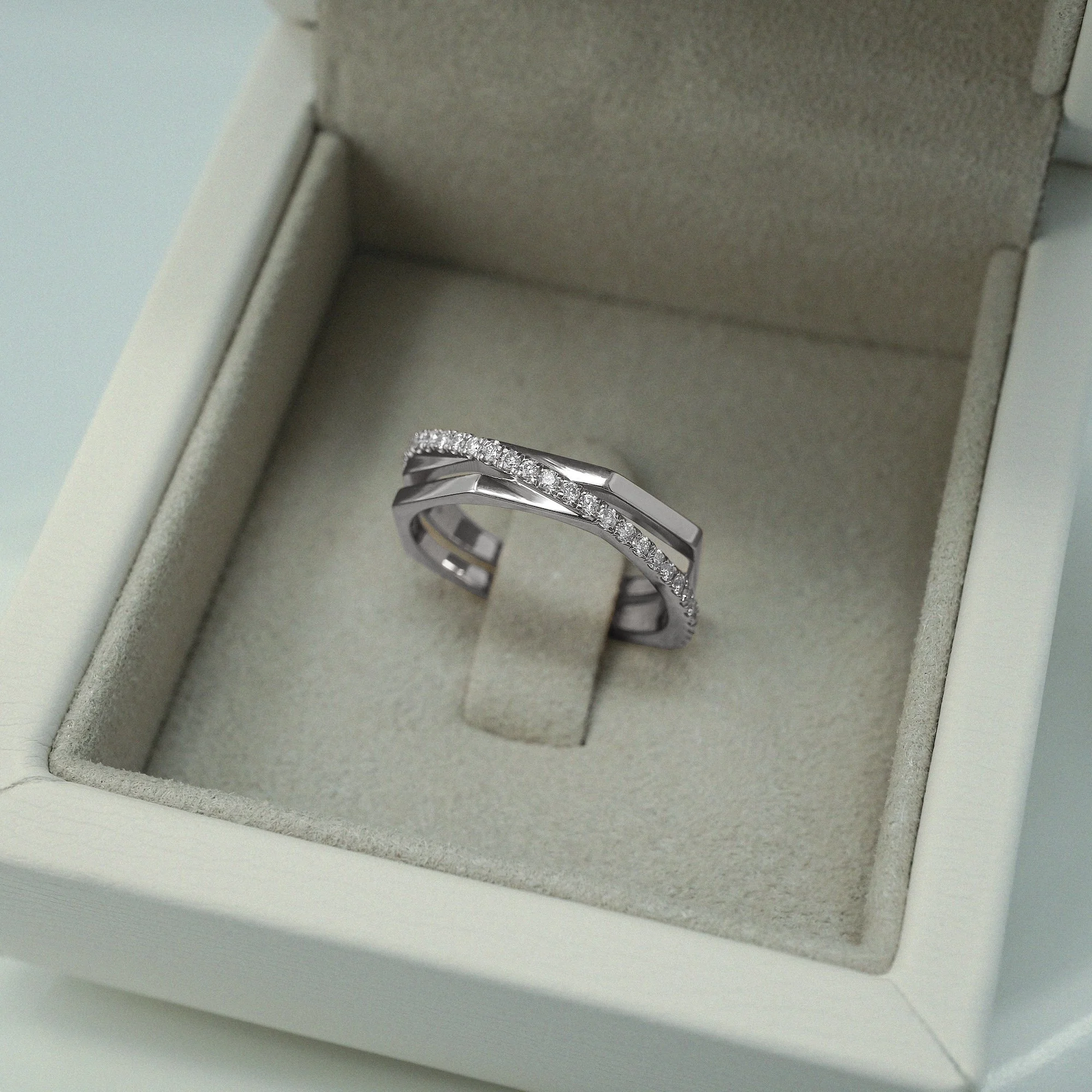 Halo Ring in platinum with round brilliant-cut white diamonds. Mindfully Handcrafted in London.