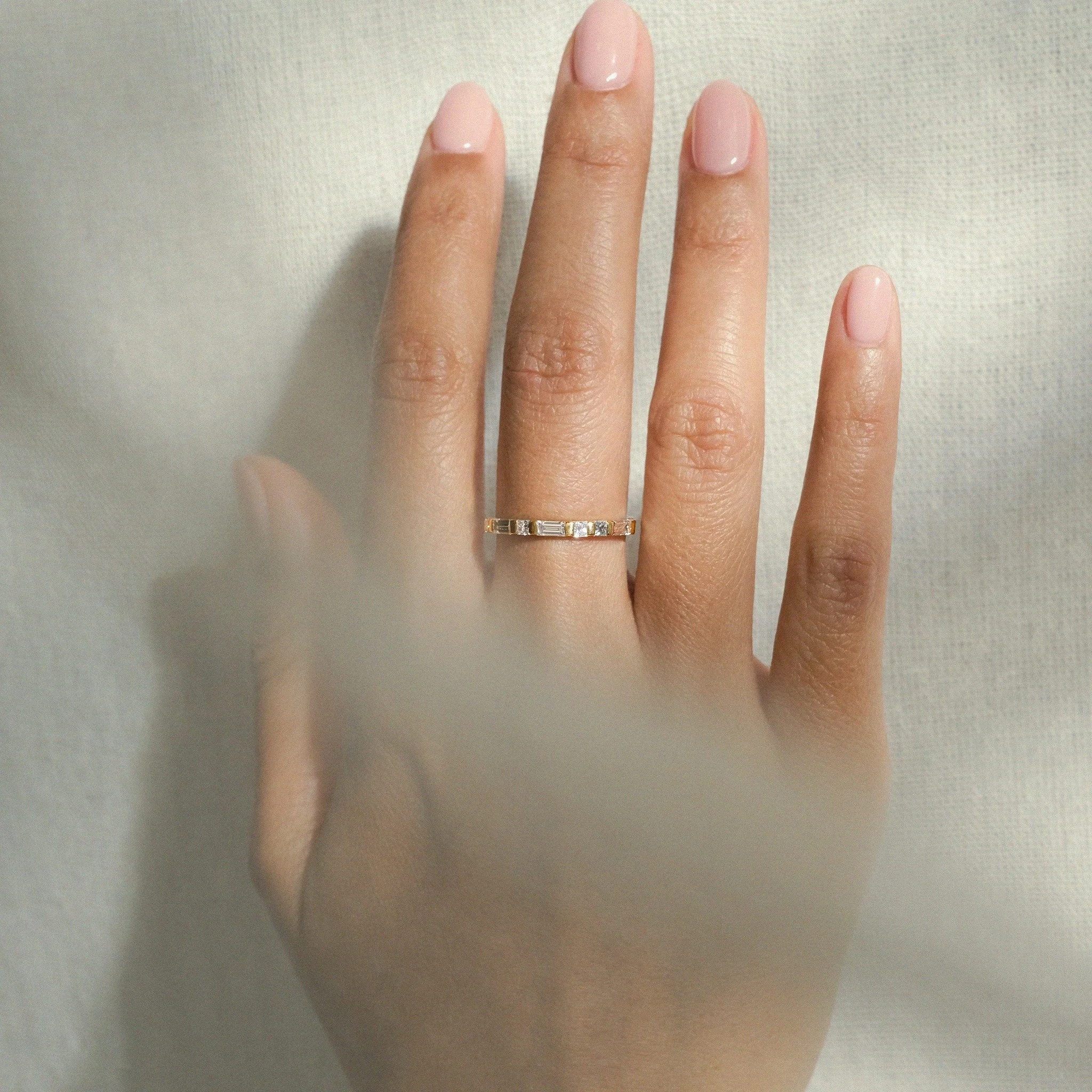 Compose your hidden message in diamond Morse code, wrapped 360 degrees around your finger. Set with princess and baguette-cut natural diamonds, this Art Deco-inspired band uses a bar setting to allow light reflection.

The Morse Bridge Ring can accom