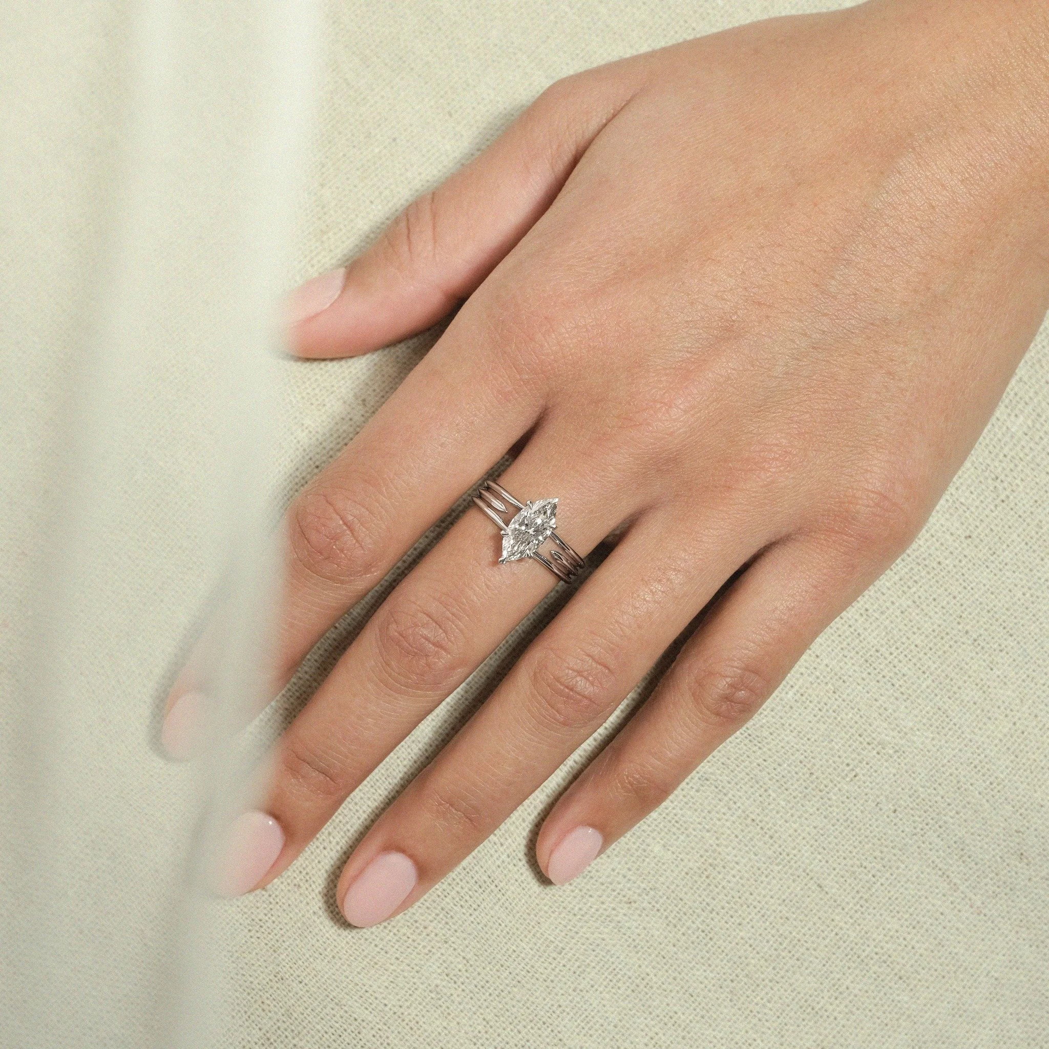 The Linxus Ring, in 18ct yellow gold or platinum, features a 1.30ct marquise-cut centre diamond set within an architectural yet minimalist three-band cut-out design, symbolising protection and strength. The futurist, architecture-inspired, faceted ba