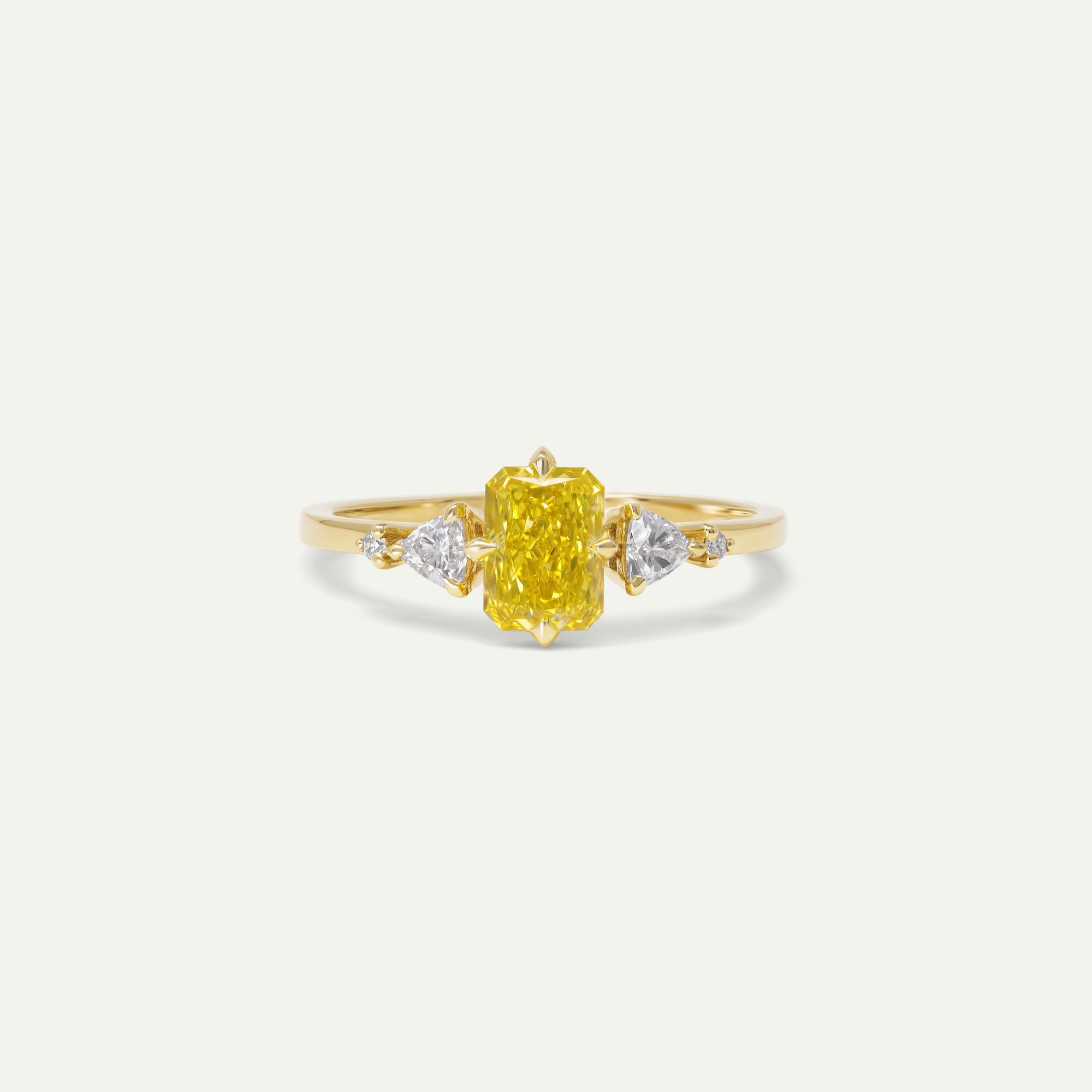 Amara ring in 18ct yellow gold engagement ring with radiant-cut yellow diamond shouldered with trilion and round brilliant-cut white diamonds from EDXU London product photo