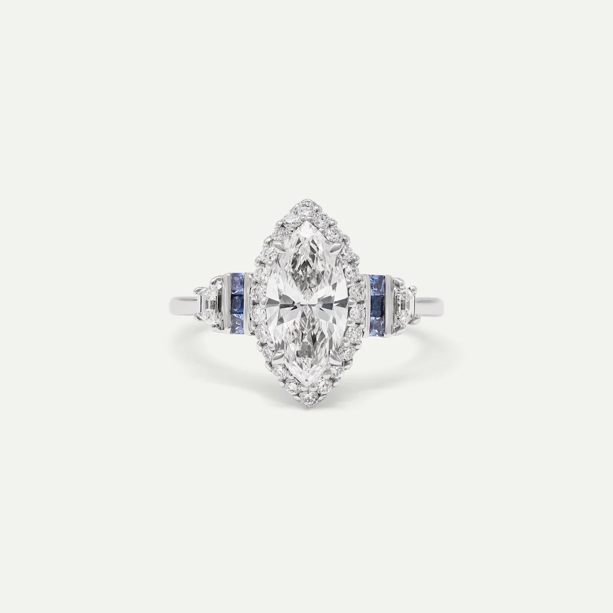 Bespoke engagement ring in platinum with 0.95ct marquise-cut, 0.21ct trapezoid-cut and 0.20ct round brilliant-cut white diamonds, and 0.18ct princess-cut royal and cornflower blue sapphires classic engagement ring from EDXU bespoke jewellery London