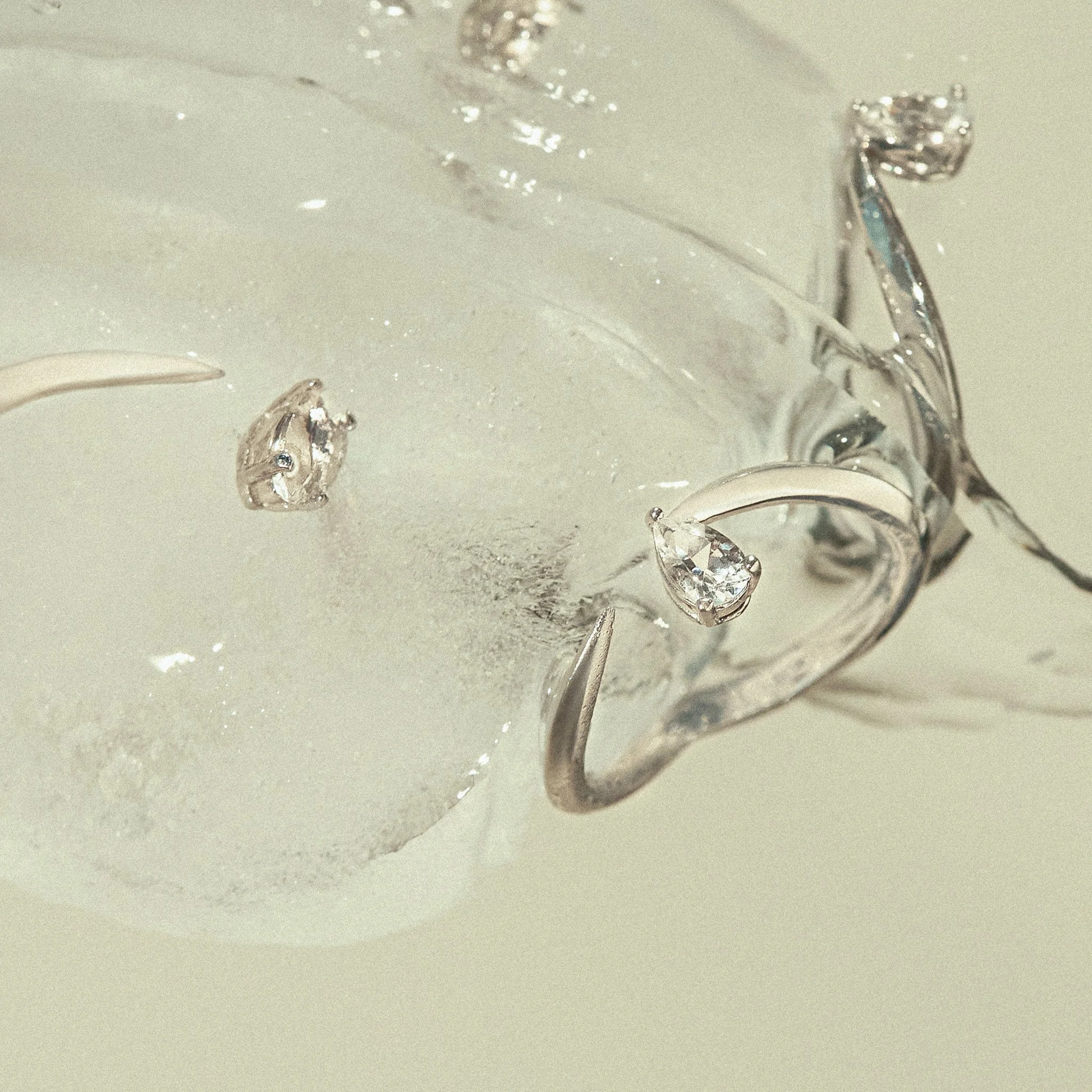 Rhodium plated sterling silver  with pear-cut white topaz Tears Drop Ring inside ice EDXU London editorial shot
