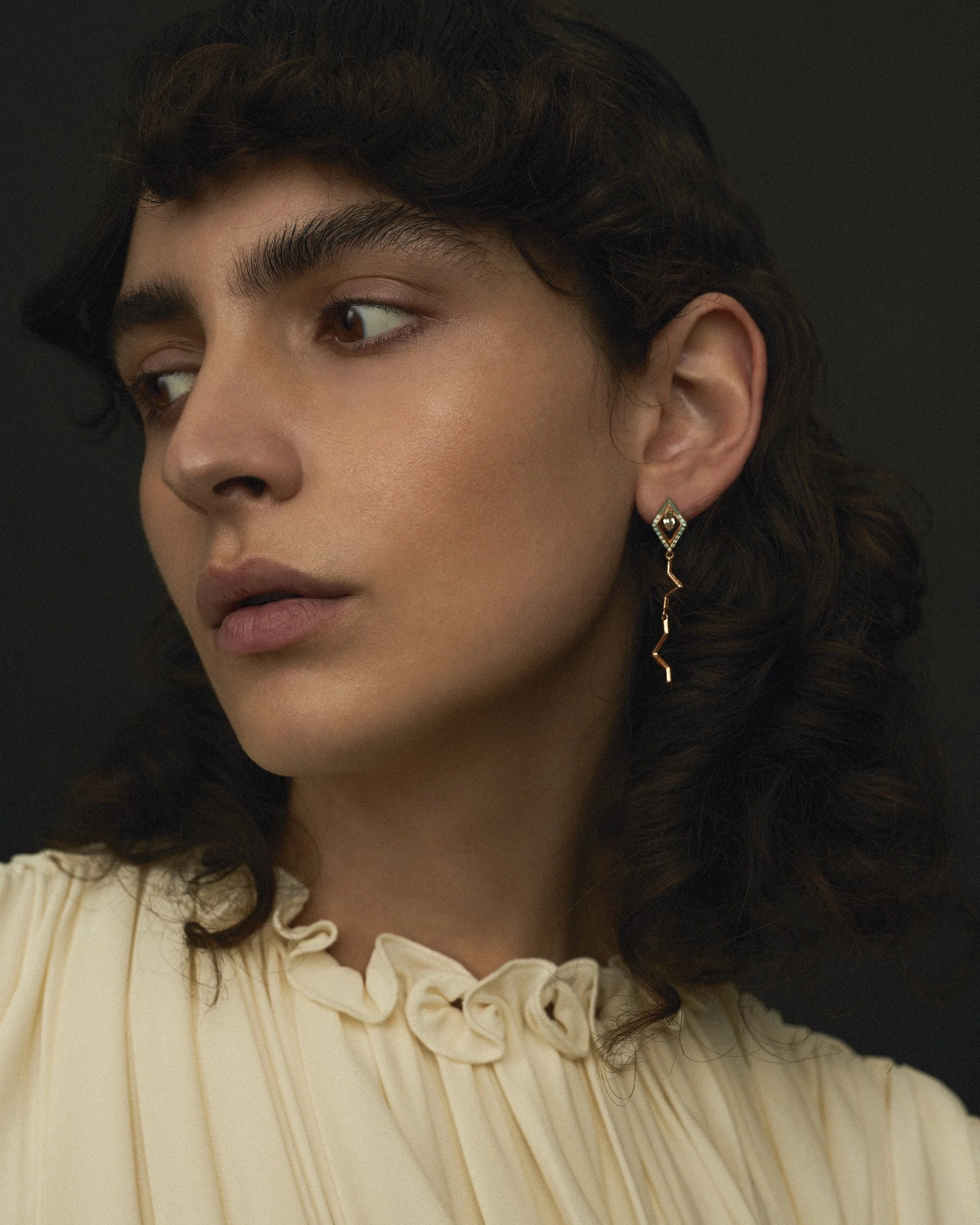 EDXU Pixel campaign of model wearing white dress with 18k rose gold Pipa Earrings with hand-painted enamel with green amethyst