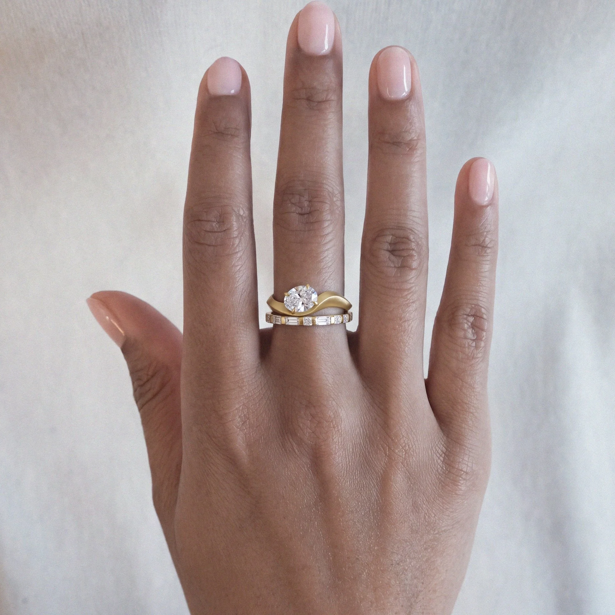 Whisper alternative engagement ring in 18ct yellow gold with oval diamond and morse code from EDXU bespoke jewellery London on model hand
