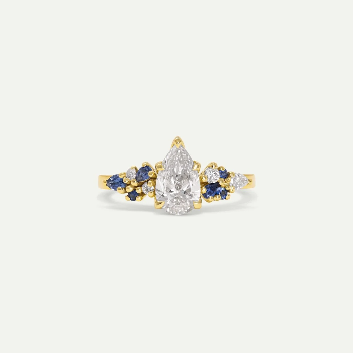 Ilias Ring in 18ct yellow gold with pear-cut white diamond and various shapes and sizes sapphires and diamonds from EDXU London bespoke jewellery
