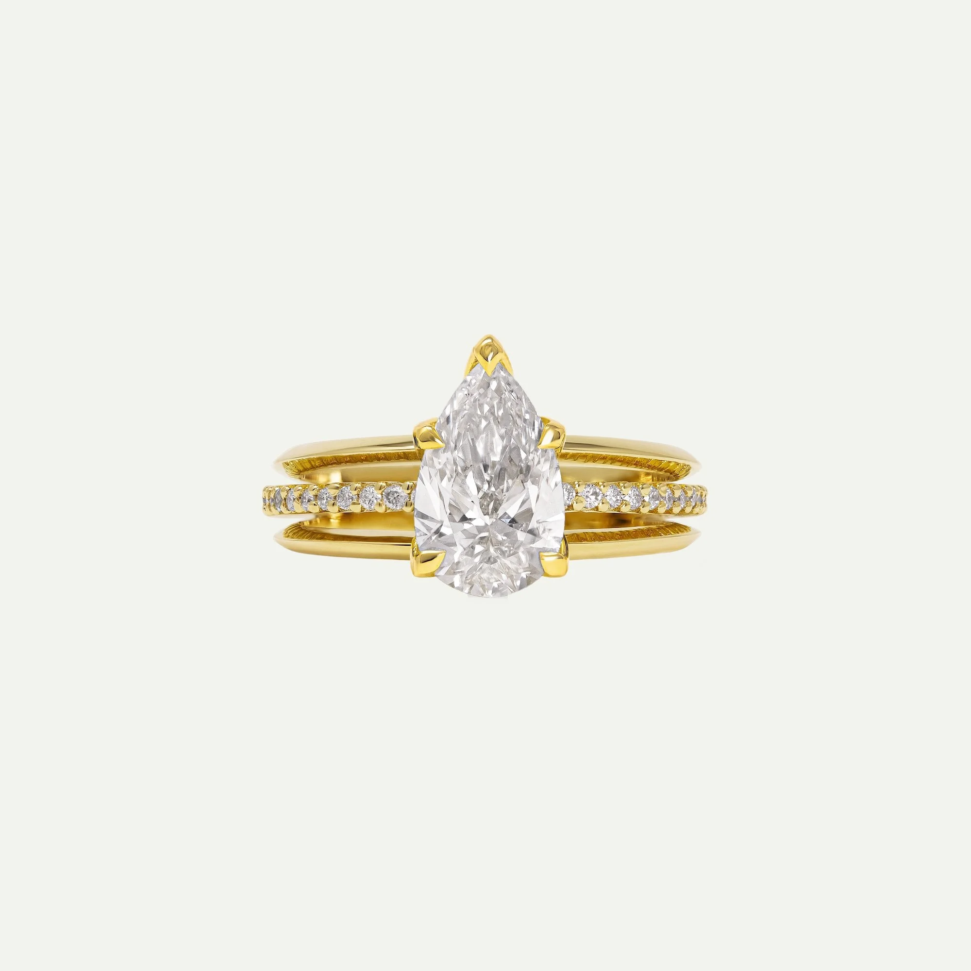 Maeve modern alternative engagement ring features a centre pear-cut diamond with architectural 3-band design with small diamond pave from EDXU bespoke jeweller London
