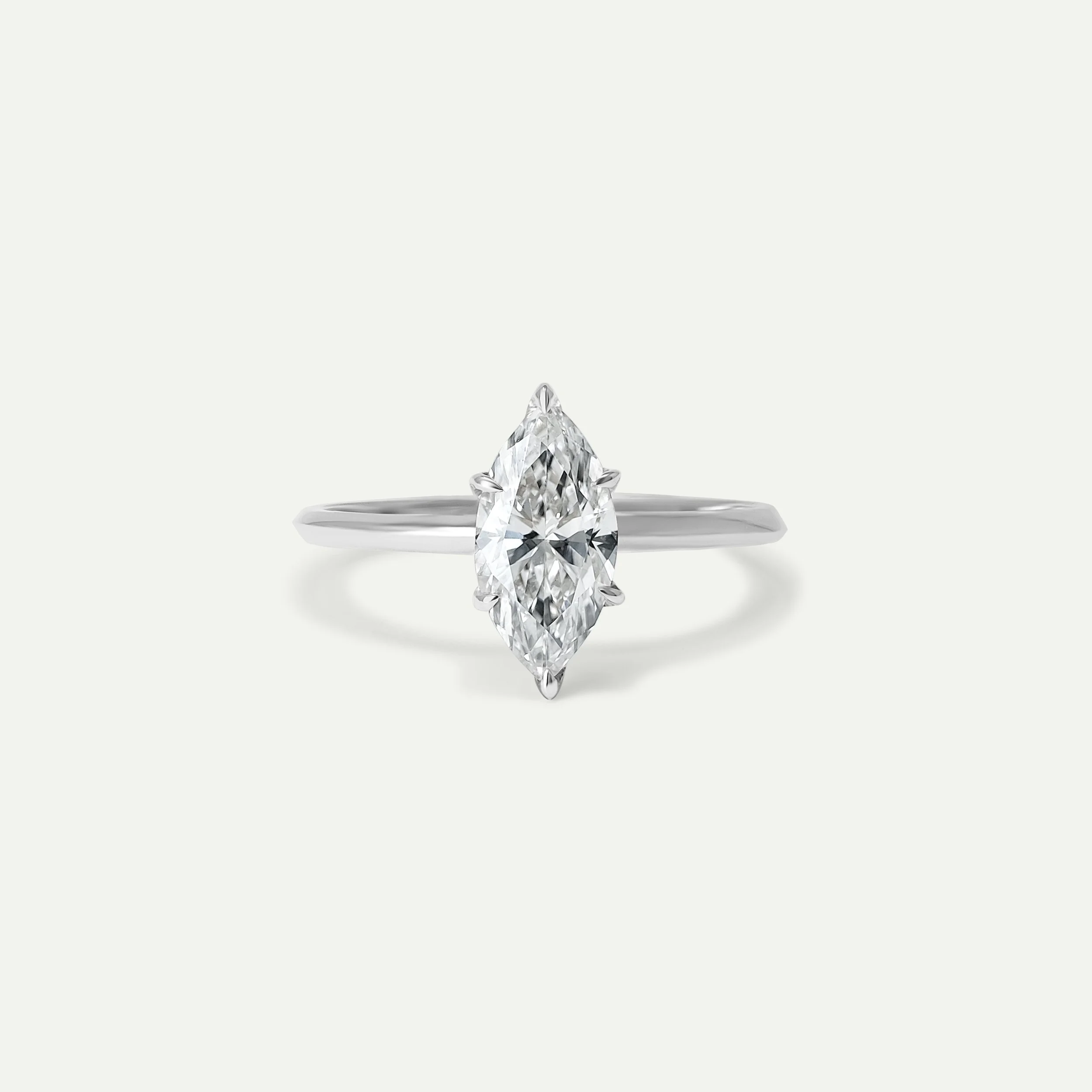 Thea Ring in highly polished shiny finish platinum with marquise-cut white diamond in twisted knife band of EDXU London front product photo